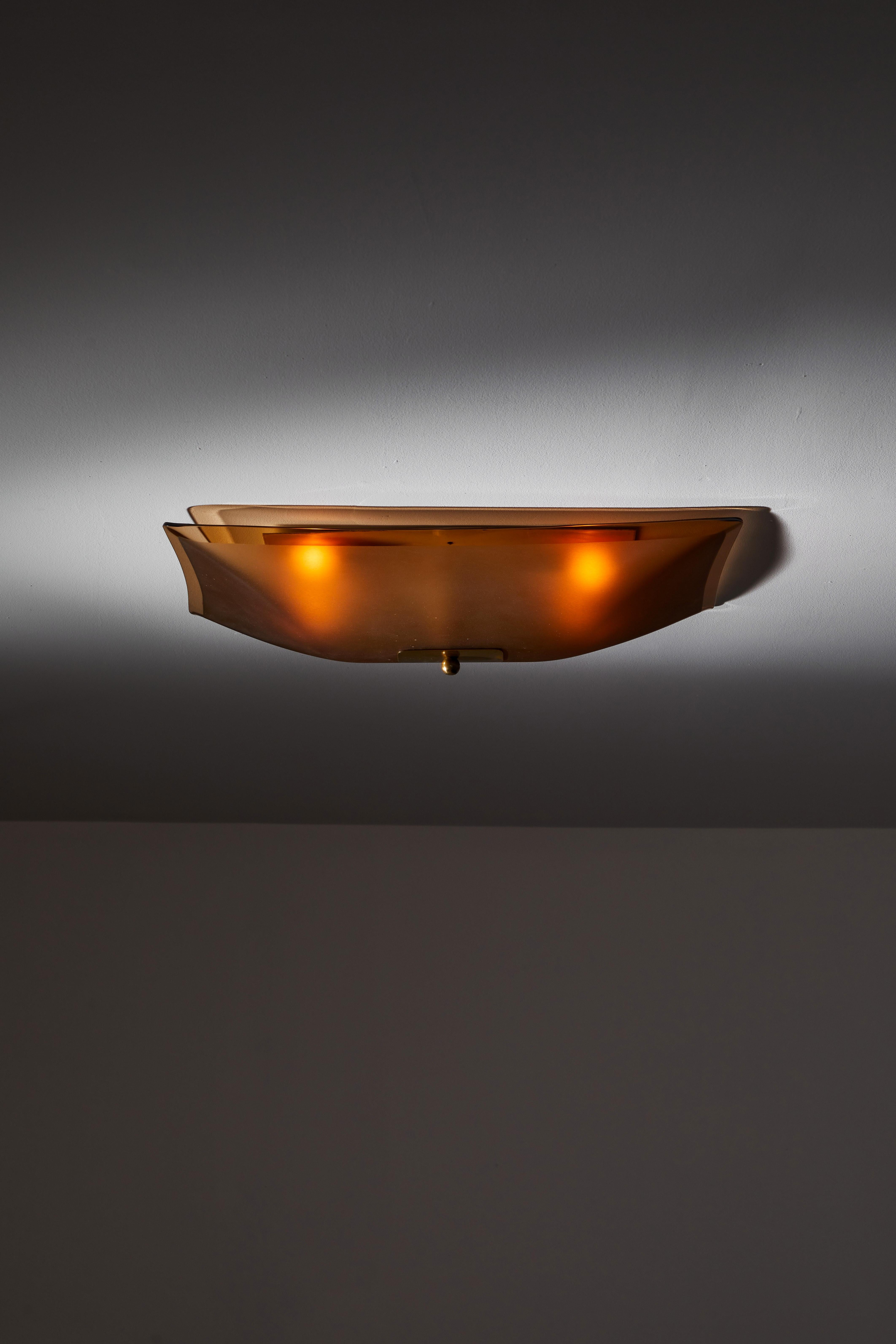 Flush mount ceiling light by Fontana Arte. Manufactured in Italy, circa 1950s. Glass, brass. Rewired for U.S. standards. This fixture has four sockets. We recommend four E27 25-60w maximum candelabra bulbs. Bulbs are provided as a one time courtesy