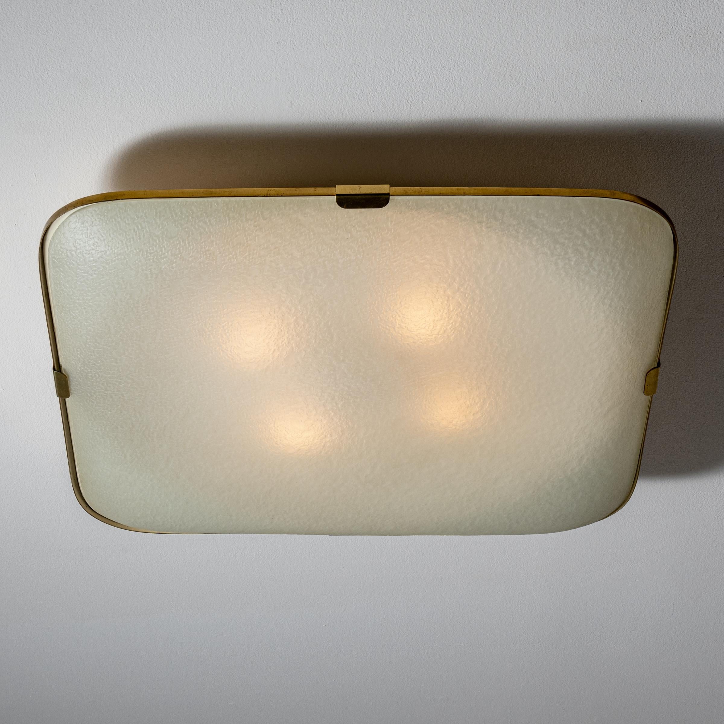 Flush mount ceiling light by Fontana Arte. Manufactured in Italy, circa 1960's. Textured glass, brass. Custom brass backplate. Rewired for U.S. standards. We recommend four E27 25w maximum bulbs. Bulbs not provided.
 Literature Quaderni Fontana