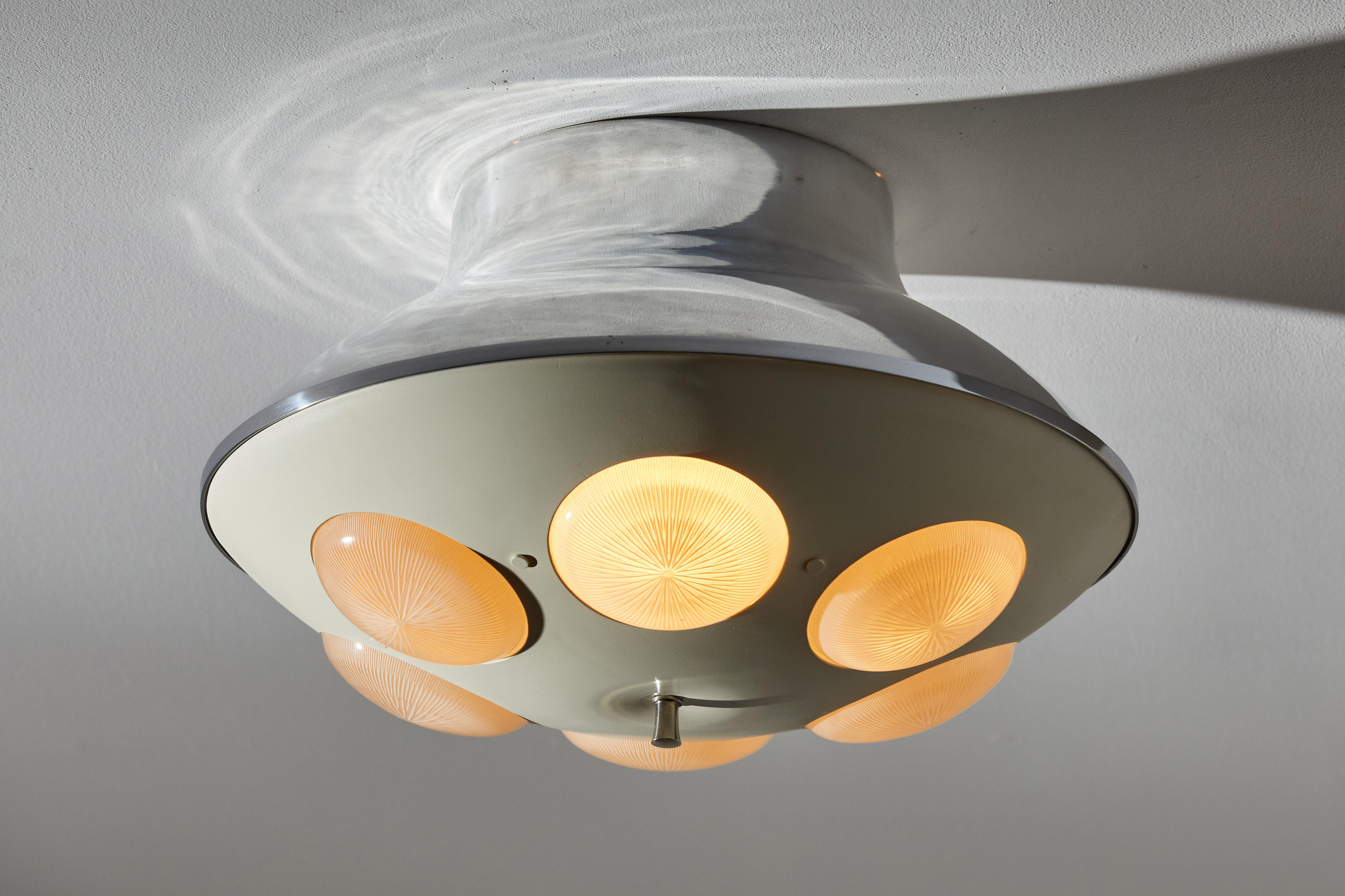 Flush mount ceiling light by Lumi. Manufactured in Italy, circa 1960s. Enameled metal, Holophane glass diffusers, brass hardware. Rewired for U.S. junction boxes. Takes three E27 candelabra bulbs and one Edison bulb. Bulbs provided as a onetime