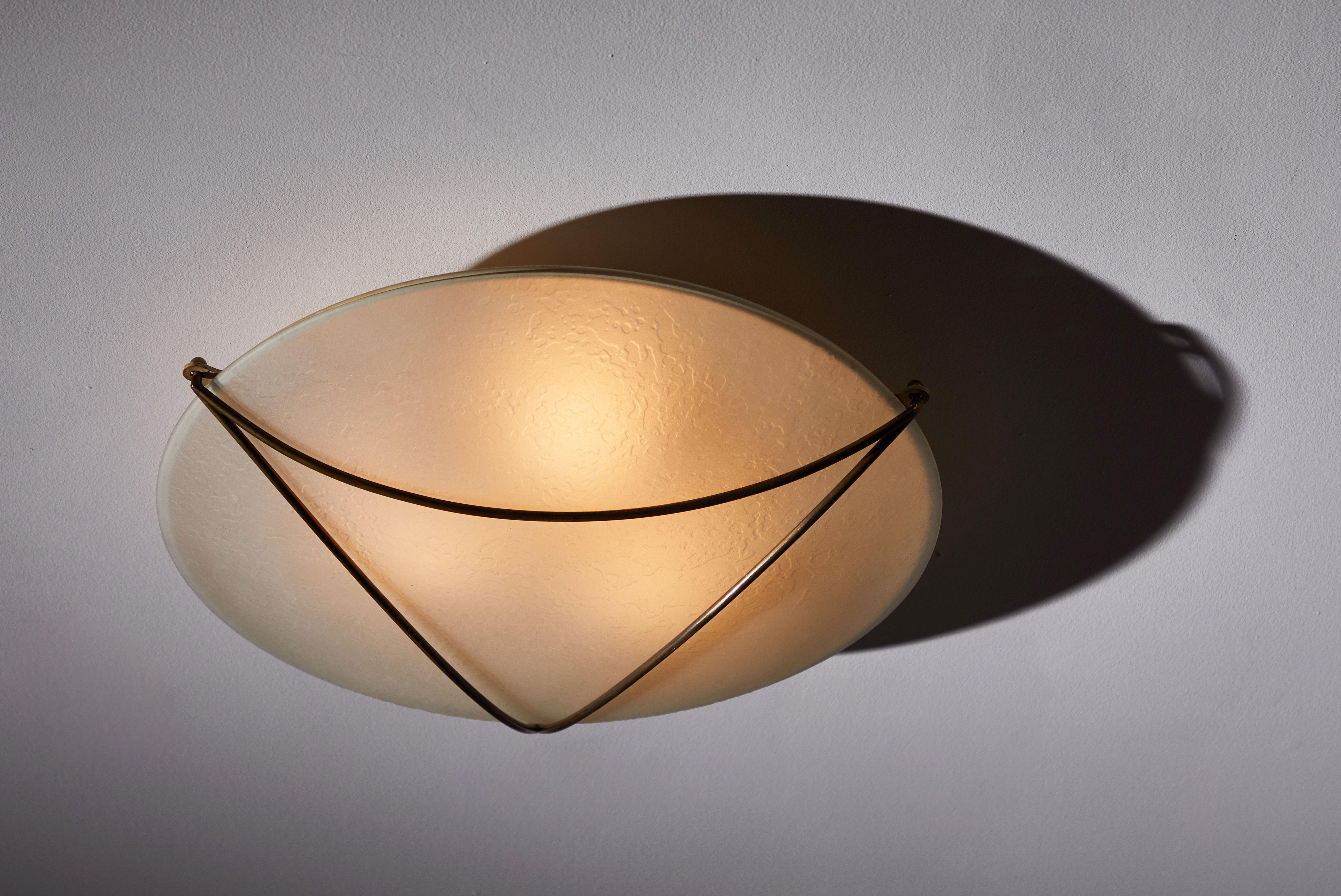 Flush mount ceiling light by Stilnovo. Manufactured in Italy circa 1950s. Opaline glass and brass. Rewired for US junction boxes. Takes three E26 25w maximum bulbs.