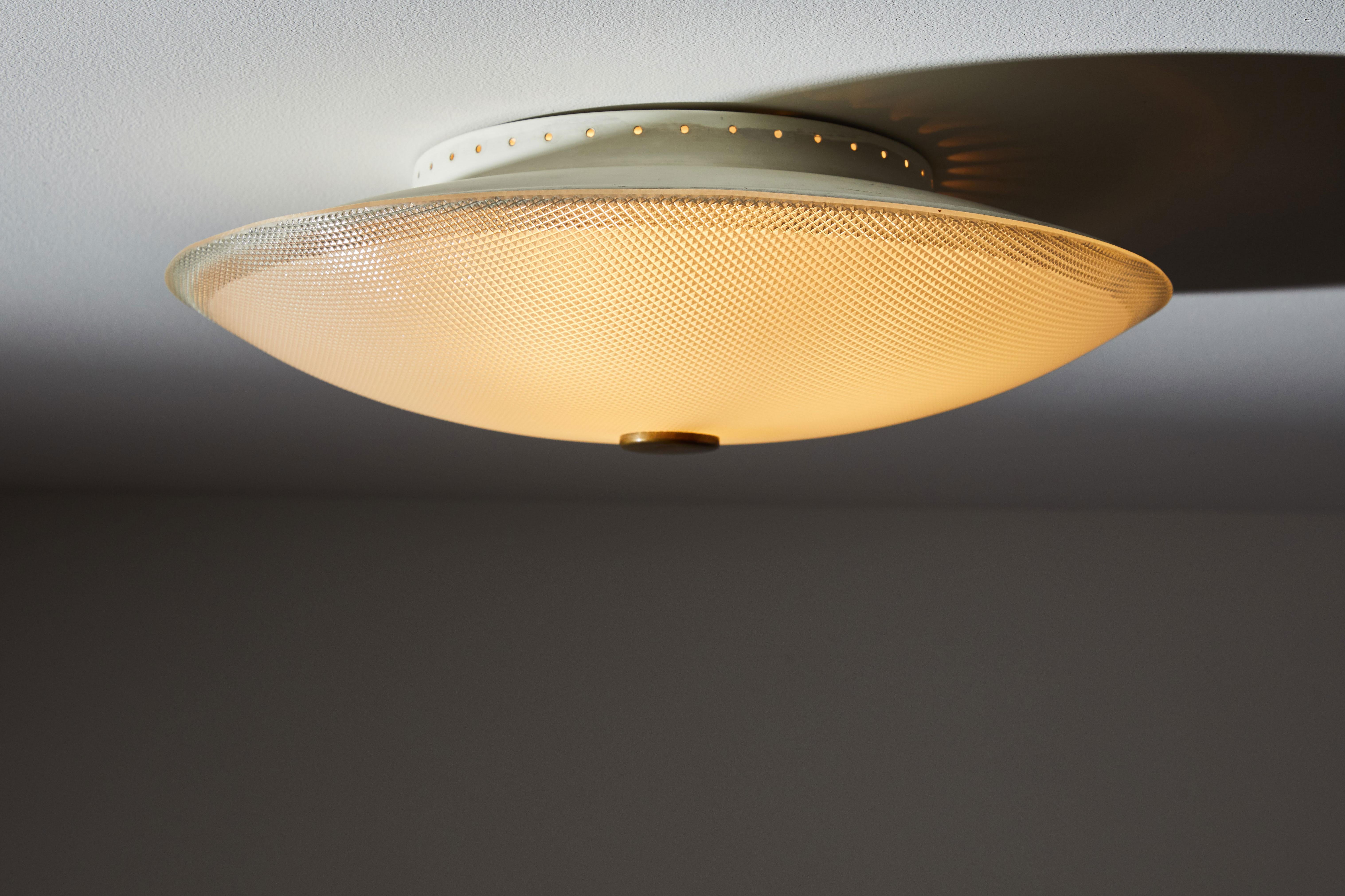 Flush mount ceiling light by Stilnovo. Manufactured in Italy circa 1960s. Brass, enameled aluminum, holophane glass. Retains original manufacturer's label. Rewired for US junction boxes. Takes three E27 40w maximum bulbs. Bulbs provided as a one