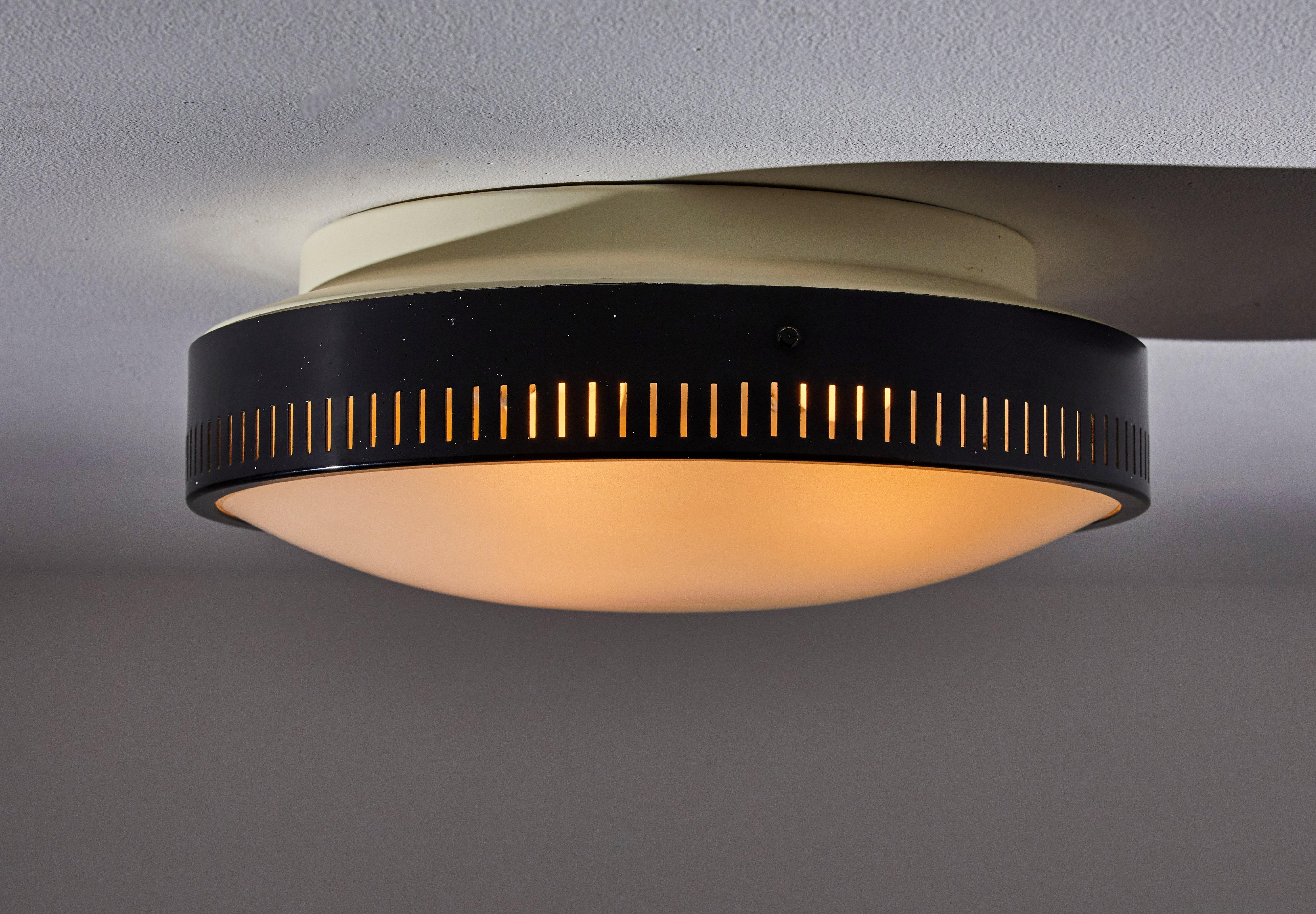 Flush mount ceiling light by Stilnovo. Manufactured in Italy, circa 1950s. Original enameled metal, opaline glass diffuser. Rewired for U.S. junction boxes. Takes three E27 60W maximum bulbs. Bulbs provided as a onetime courtesy.
