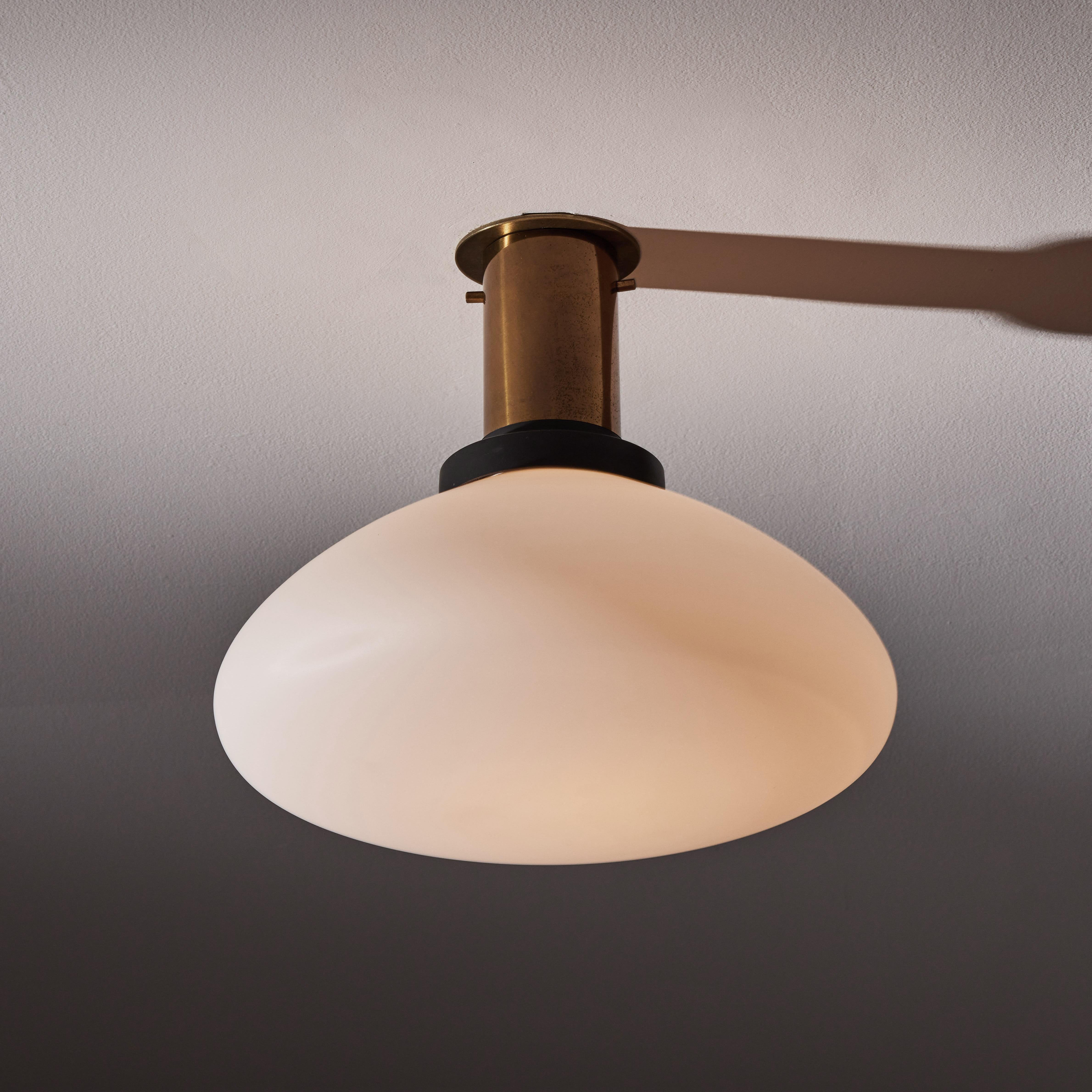 Flush mount ceiling light by Stilnovo. Manufactured in Italy, circa 1960's. Brushed satin glass diffuser, brass, enameled metal. Custom brass backplate. Wired for U.S. standards. We recommend one E27 60w maximum bulb. Bulb provided as a one time