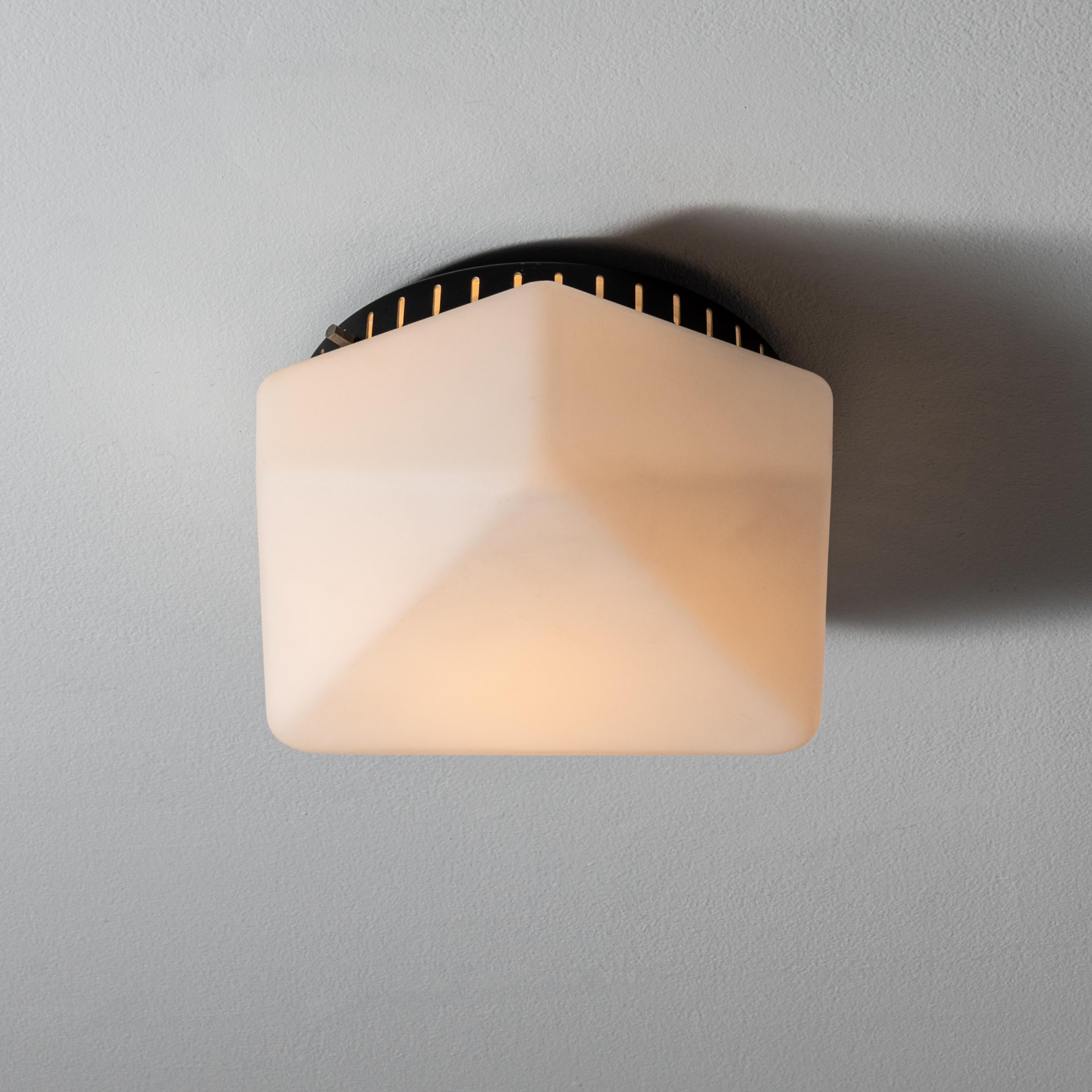 Flush mount ceiling light by Stilnovo. Manufactured in Italy, circa. 1960. Perforated sheet metal, brushed satin glass diffuser. Rewired for U.S. standards. We recommend one E27 100w maximum bulb. Bulb not included.

 
