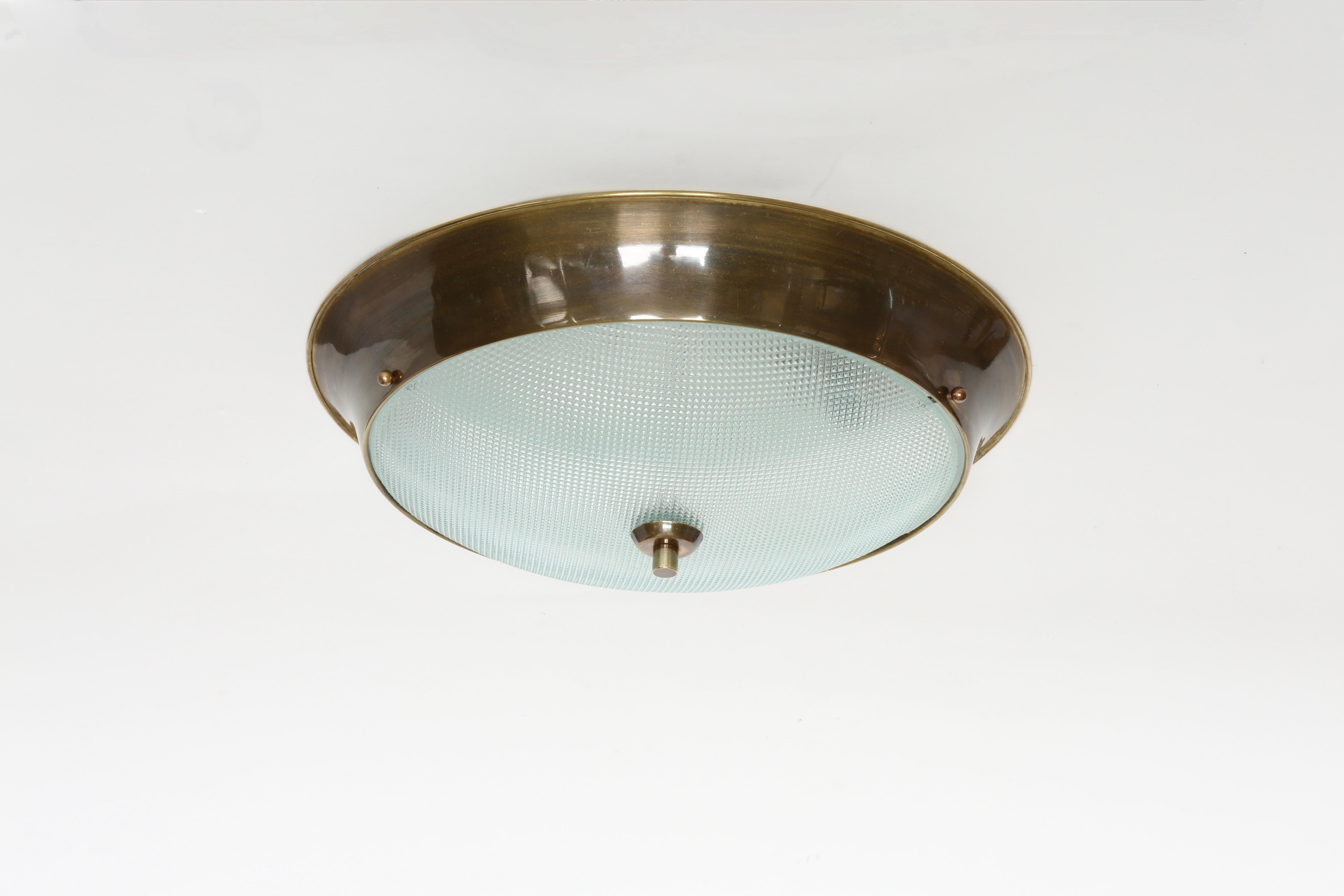 Flush mount ceiling light.
Designed and made in Italy in 1960s
Textured glass, patinated brass.
Takes 2 Edison bulbs.
Complimentary US rewiring upon request.
Four flush mounts are available.
Priced is for one light.

We take pride in bringing