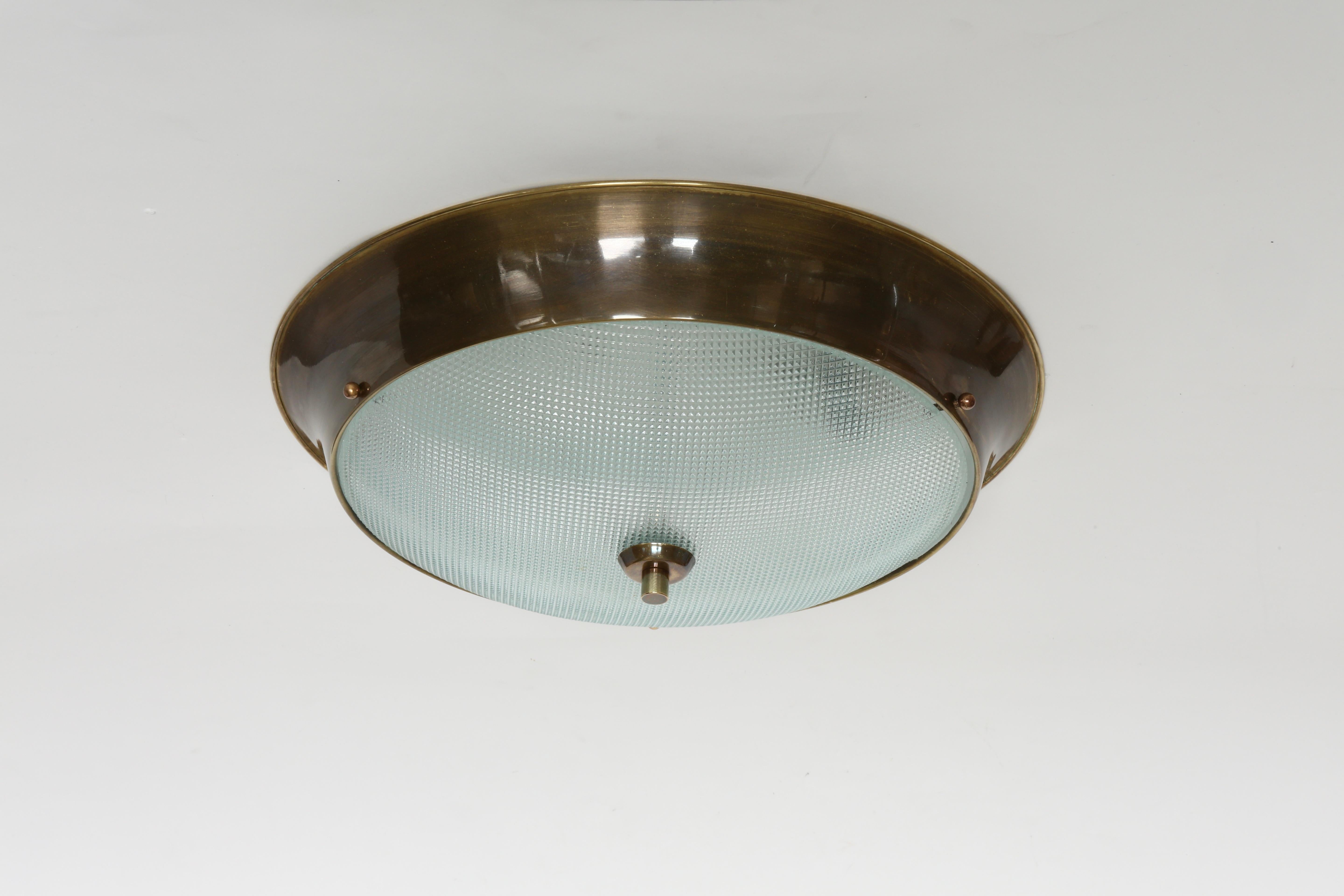 Flush mount ceiling light.
Designed and made in Italy in 1960s
Textured glass, patinated brass.
Takes 2 Edison bulbs.
Rewired for US.
Four flush mounts are available.
Price is for one light.

We take pride in bringing our vintage fixtures to their