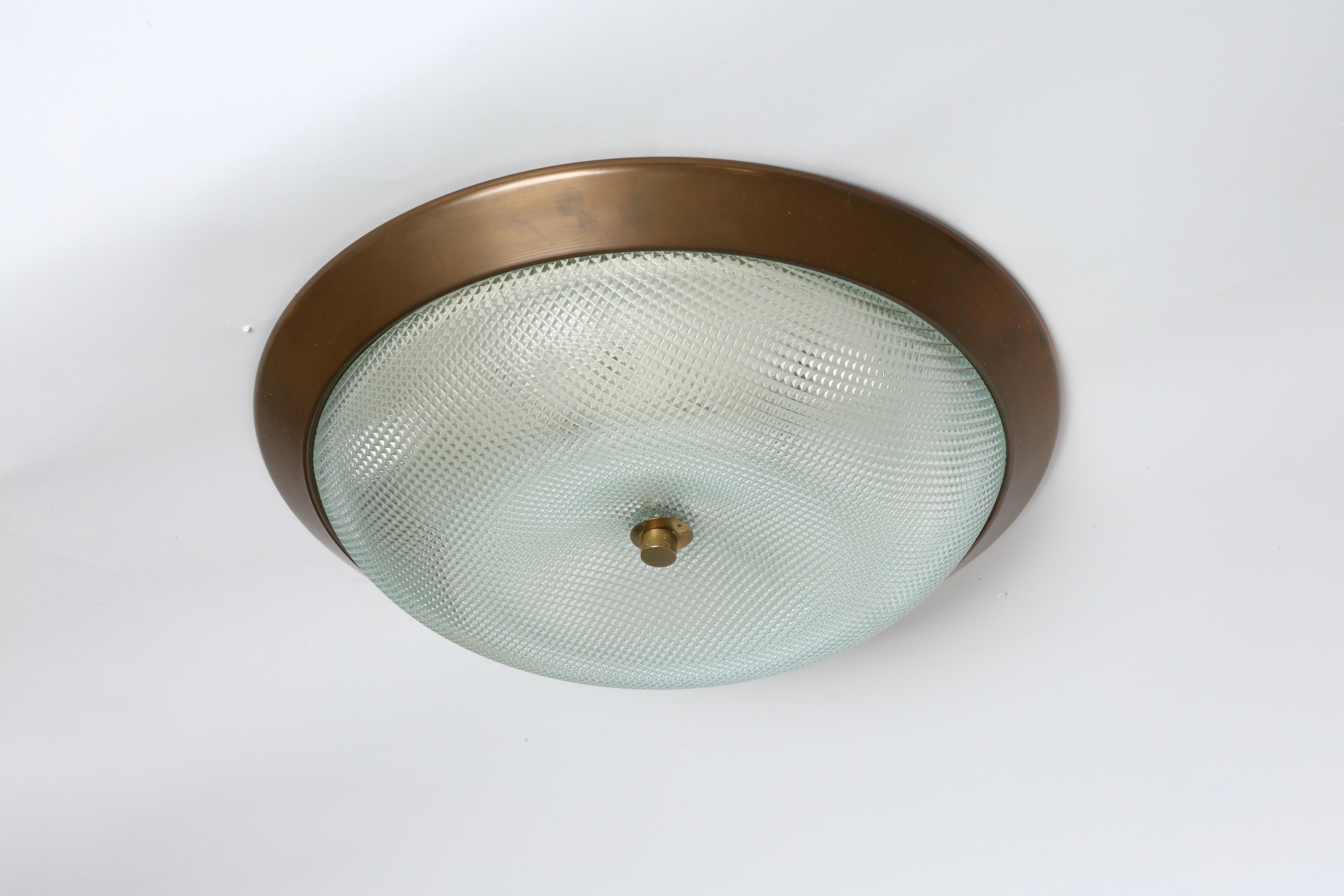 Flush mount ceiling light.
Designed and made in Italy in 1960s
Textured glass, patinated brass.
Takes 3 candelabra bulbs.
Complimentary US rewiring upon request.


