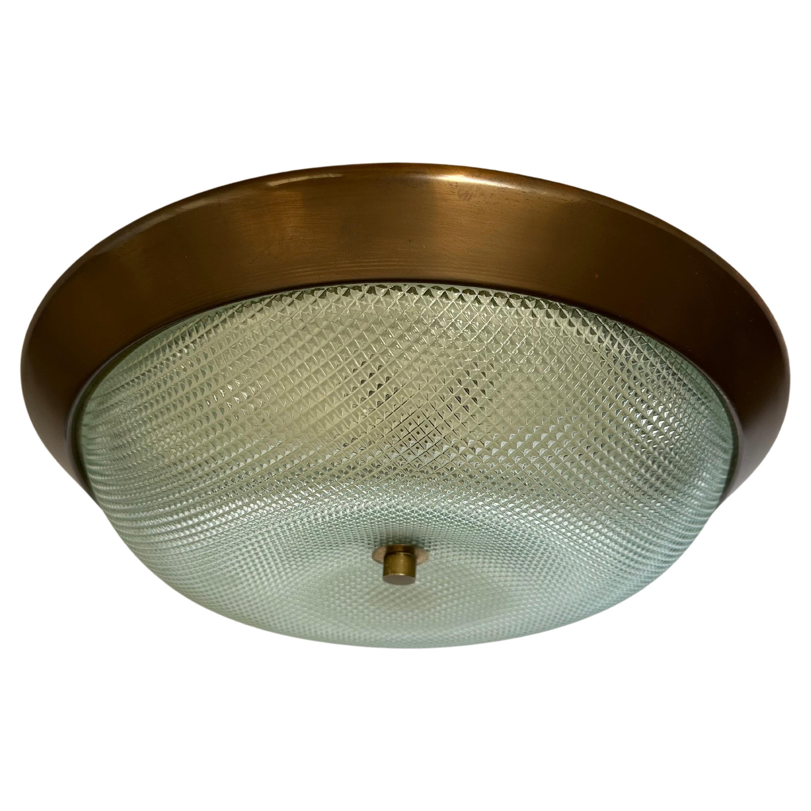 Flush mount ceiling lights.
Designed and made in Italy in 1960s
Textured glass, patinated brass.
Takes 3 candelabra bulbs each.
Complimentary US rewiring upon request.
Three flush mounts are available.
Price is for one flush mount.

At Illustris