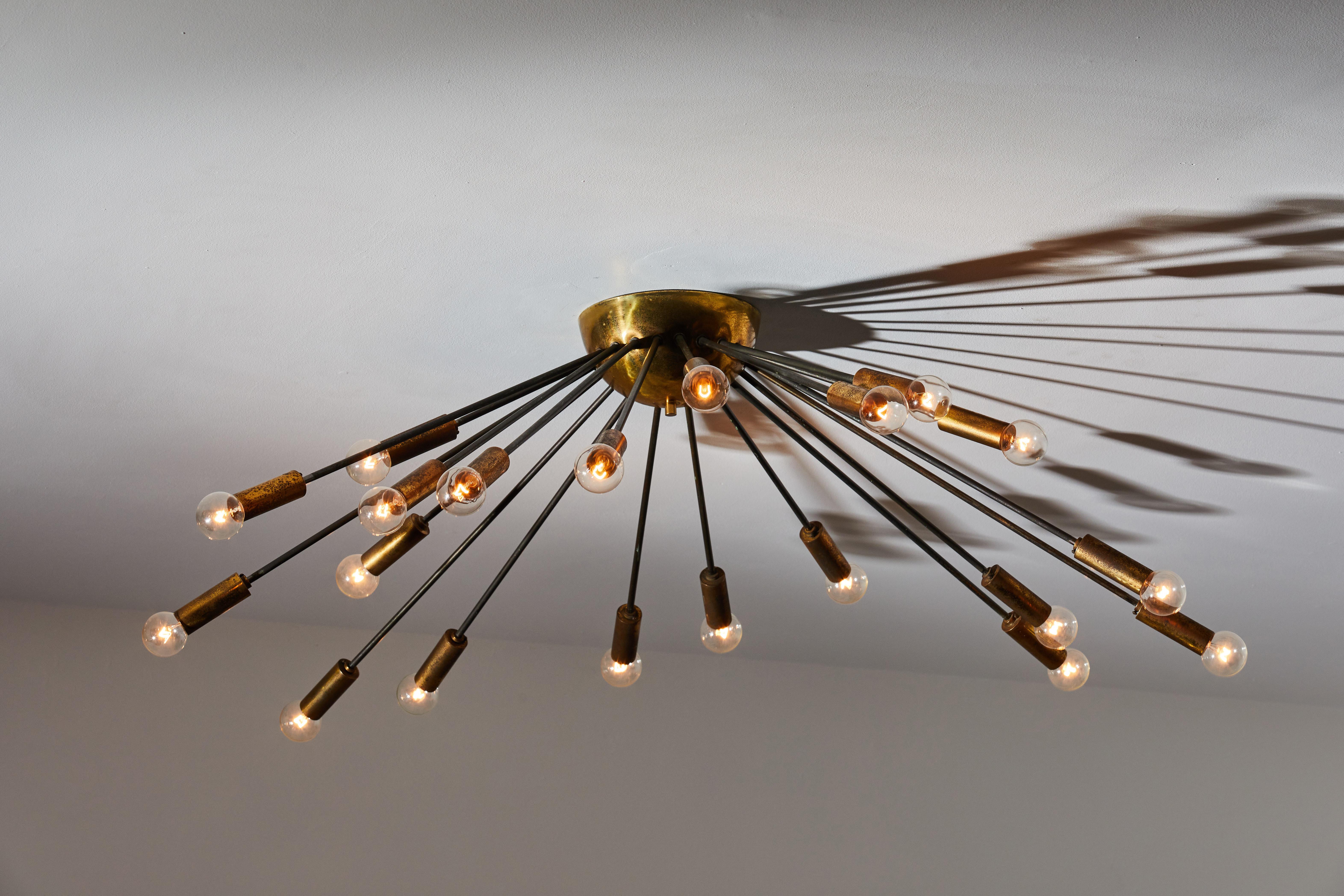 Twenty arm flush mount chandelier by Stilnovo. Manufactured in Italy, circa 1950s. Rewired for U.S. junction boxes. Brass. Takes 20 E27 candelabra 40w maximum bulbs. Bulbs provided as a one time courtesy.