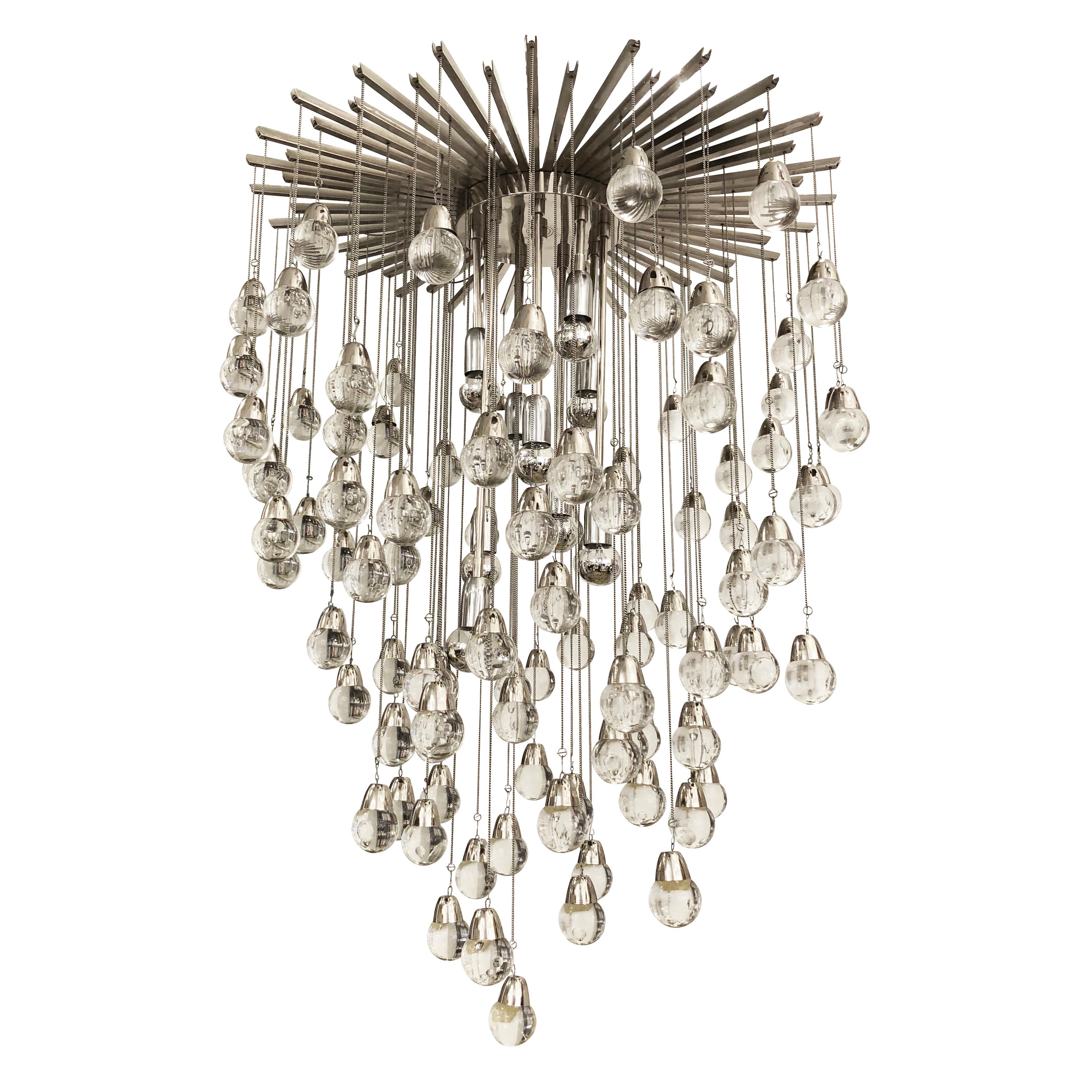 Eye-catching chandelier made with more than ninety glass spheres hanging from a star-shaped canopy. Nine stems with sockets come down from the star structure. Light bulbs are located at the same height of the spheres making them blend in. The height