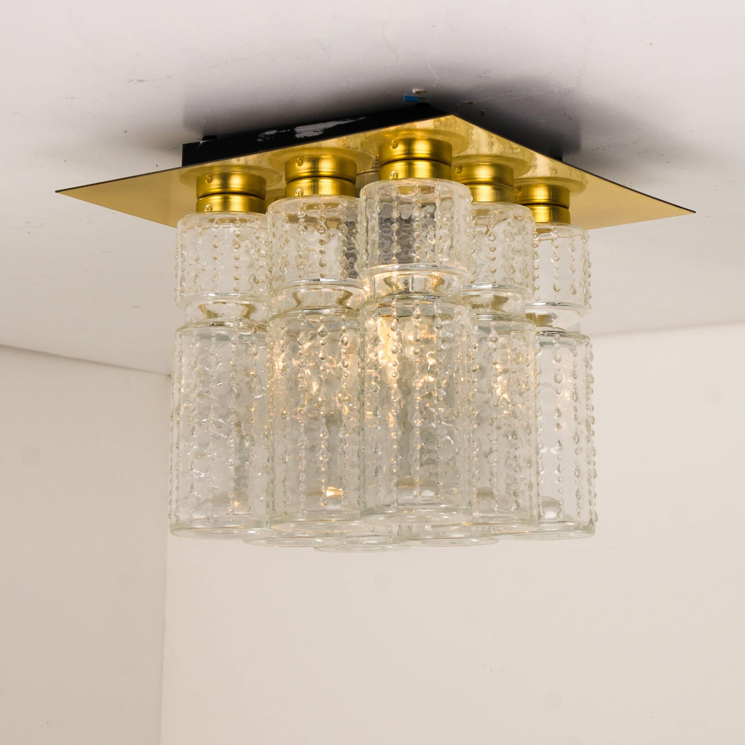 Amazing flush mount chandelier with eight hanging hand blow textured hollow glass prisms mounted on a brass frame. Made by Glashütte Limburg in Germany designed by Boris Tabacoff in the 1970s.

Excellent original condition. Fitted with one E27