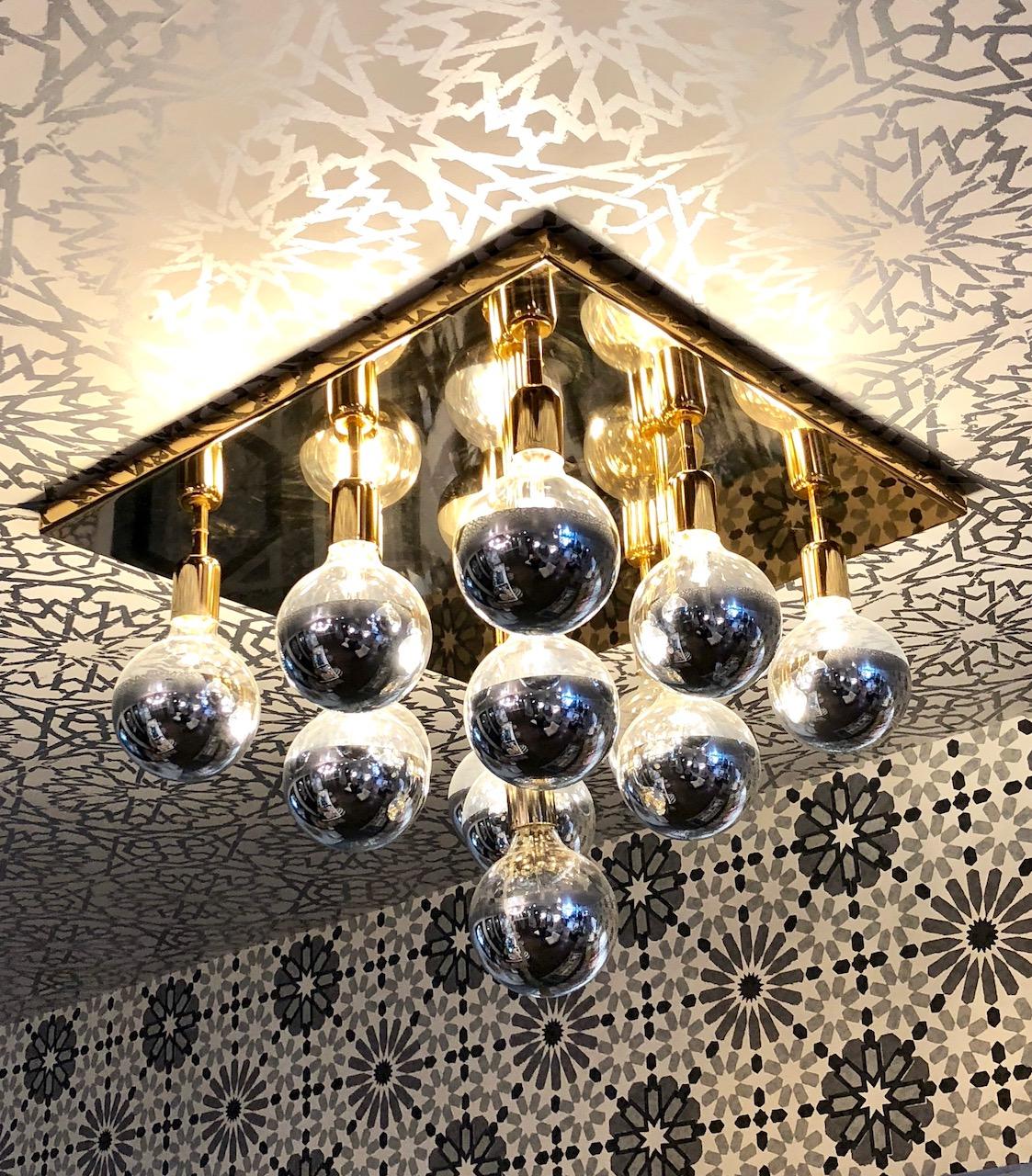 Brass flush mount light fixture. Square brass base with 13 dimmable mirrored top Bulbrites.
Can be installed as a ceiling or wall/sconce light.