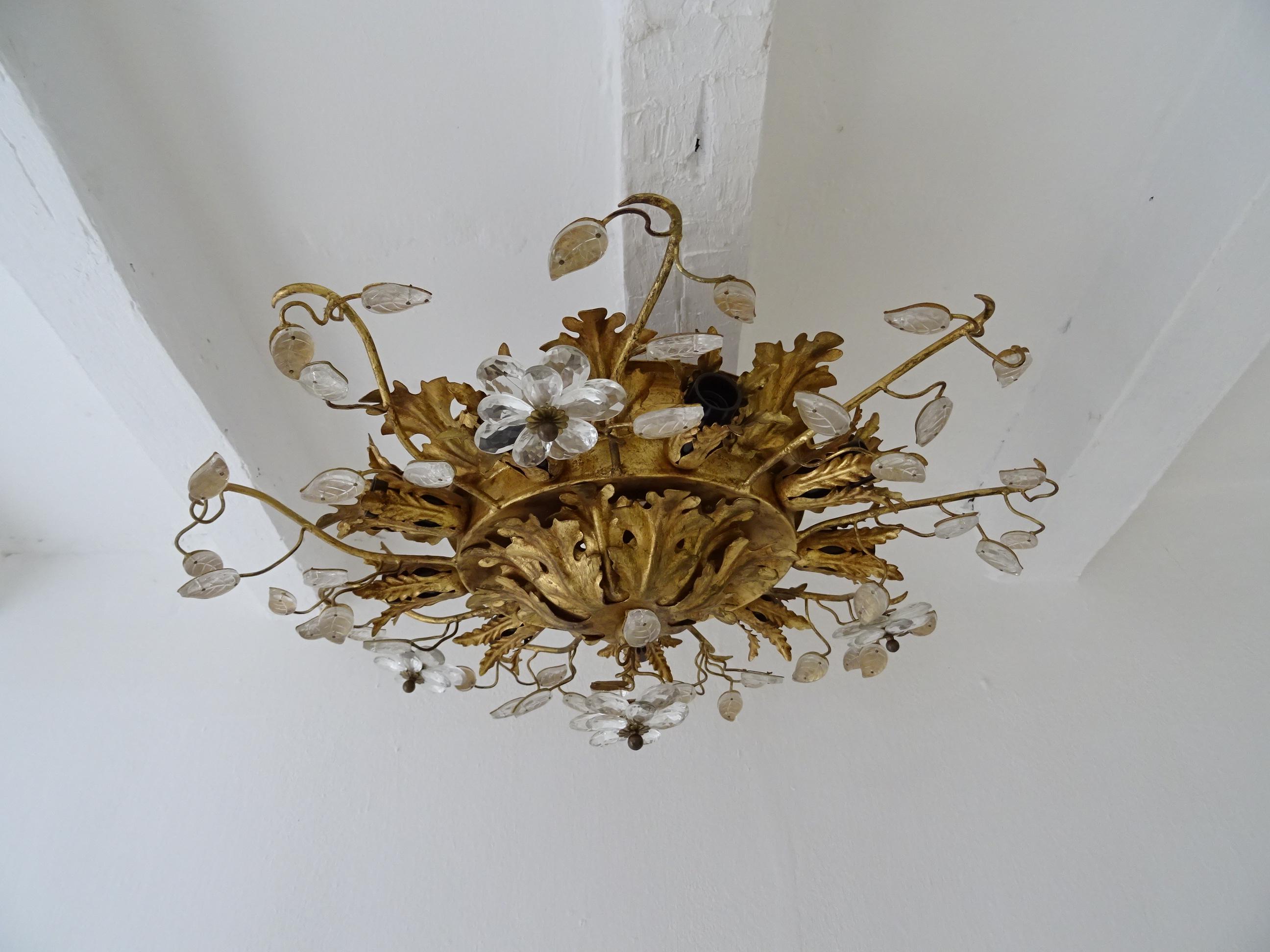 Housing 9 lights. Will be rewired free of charge with certified UL US sockets for the USA and appropriate sockets for all other countries and ready to hang. Gold tole with perfect patina. Crystal prism double flowers, smaller on top. Signed Bagues.