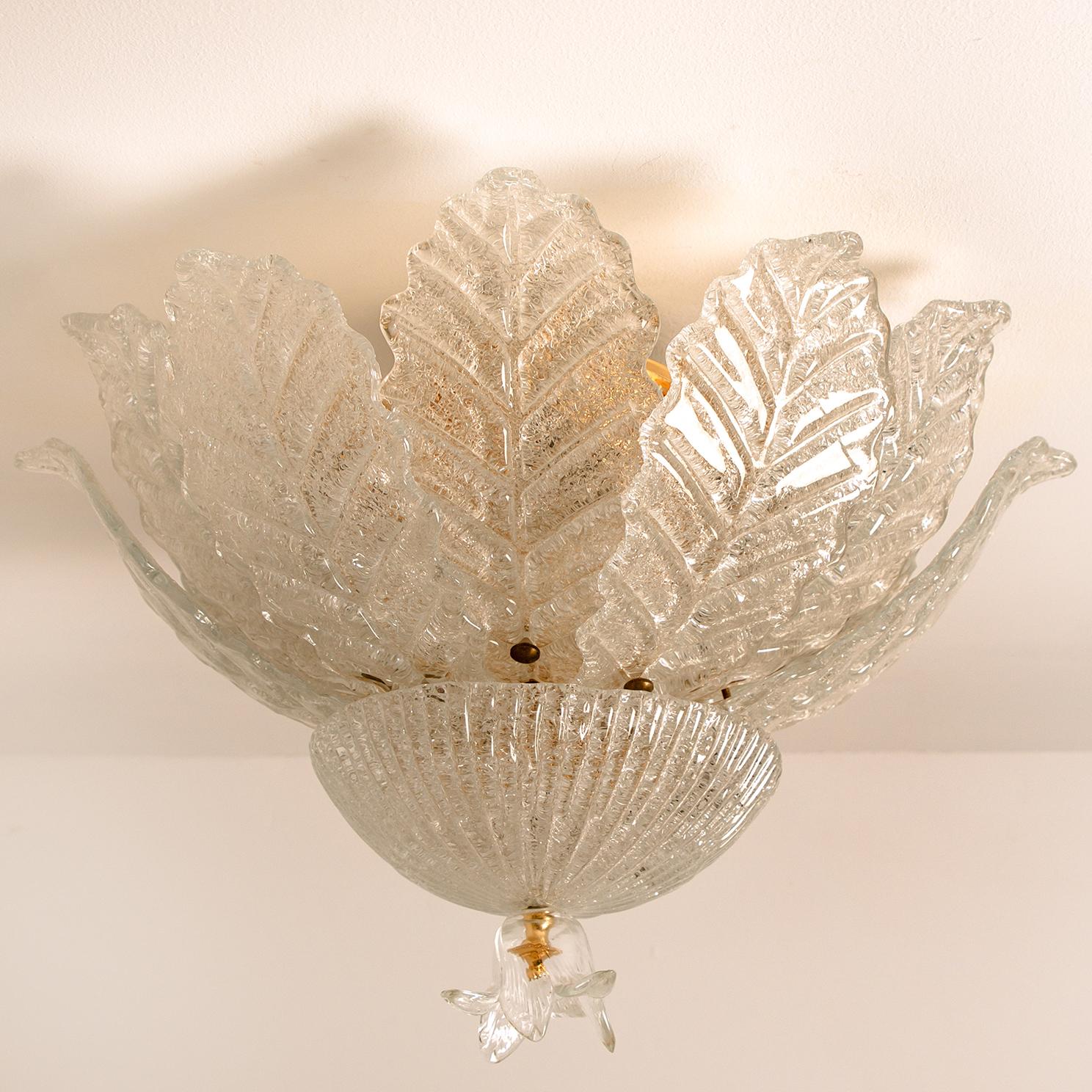 An elegant hand blown Murano glass flush mount of Barovier & Toso. The light fixture consists 12 blown Murano glass leaves. Mounted on an brass frame. The leaves refract light beautifully. The flush mount fills the room with a soft, warm and