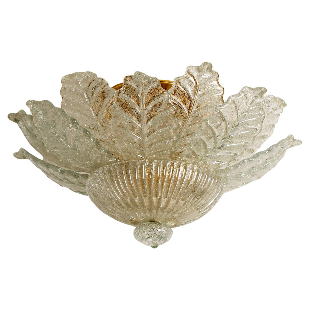 An elegant hand blown Murano glass flush Mount of Barovier & Toso. The light fixture consists 16 blown Murano glass leaves. Mounted on a brass frame. The leaves refract light beautifully. The flush mount fills the room with a soft, warm and