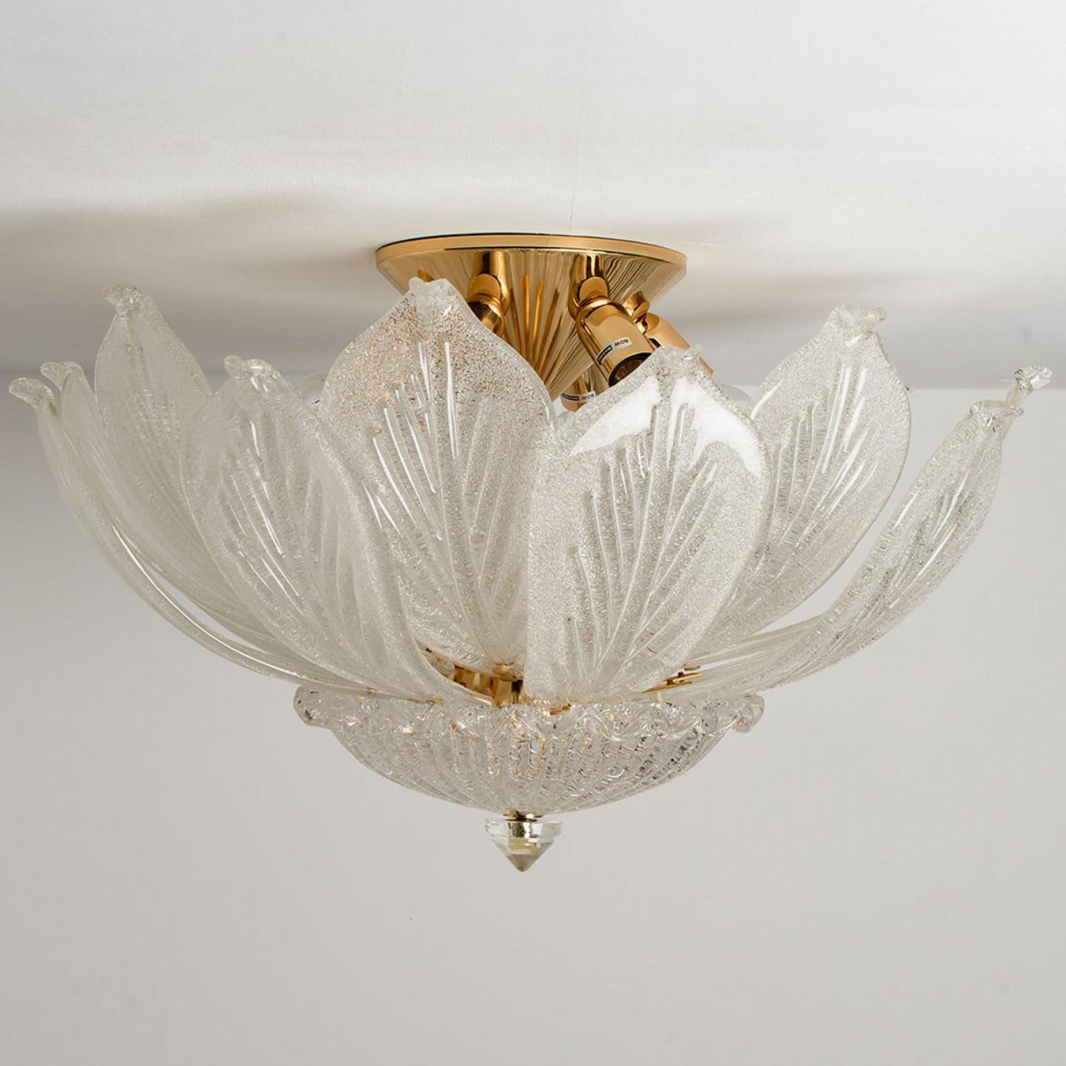 Onee elegant hand blown Murano glass flush mount of Barovier & Toso. Made in Italy, Europe, around 1970. The light fixture consists of 16 blown Murano glass leaves. Mounted on a brass frame. The leaves refract light beautifully. The flush mount