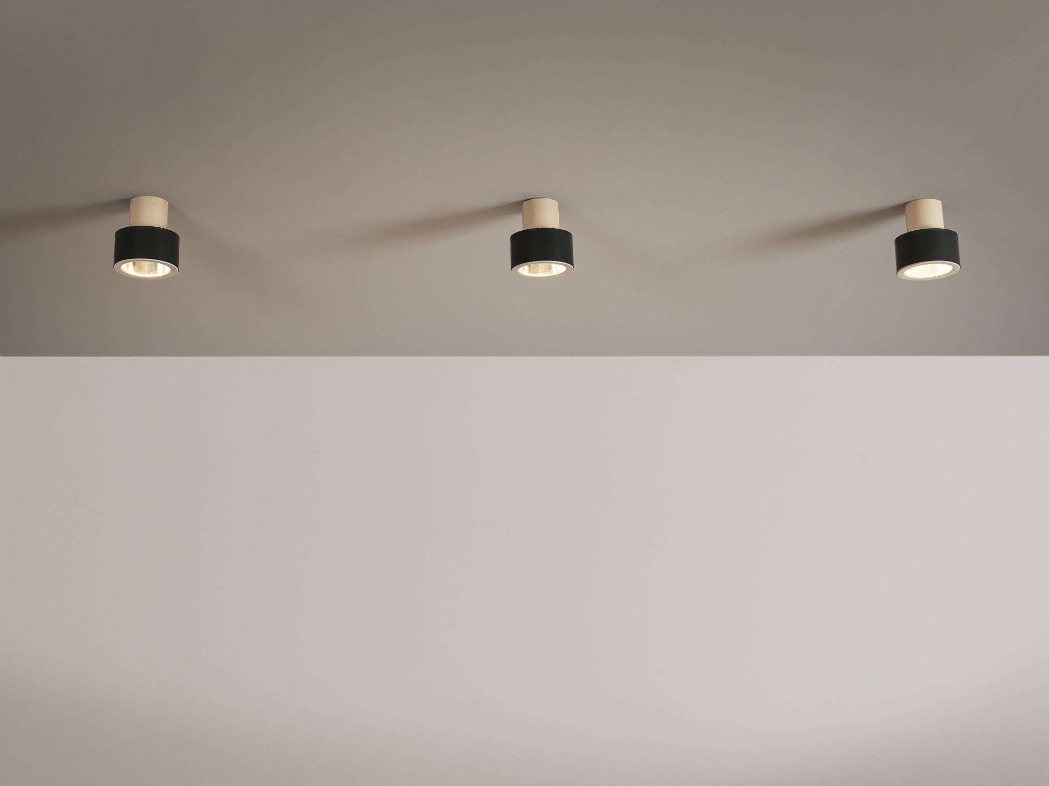 Flush mount pendants, metal, Europe, 1970s. 

Circular pendants consisting of two parts in black and white lacquered metal. A fresh design in neutral colors made in Europe in the 1970s. The shade is quite large, making it a remarkable light source