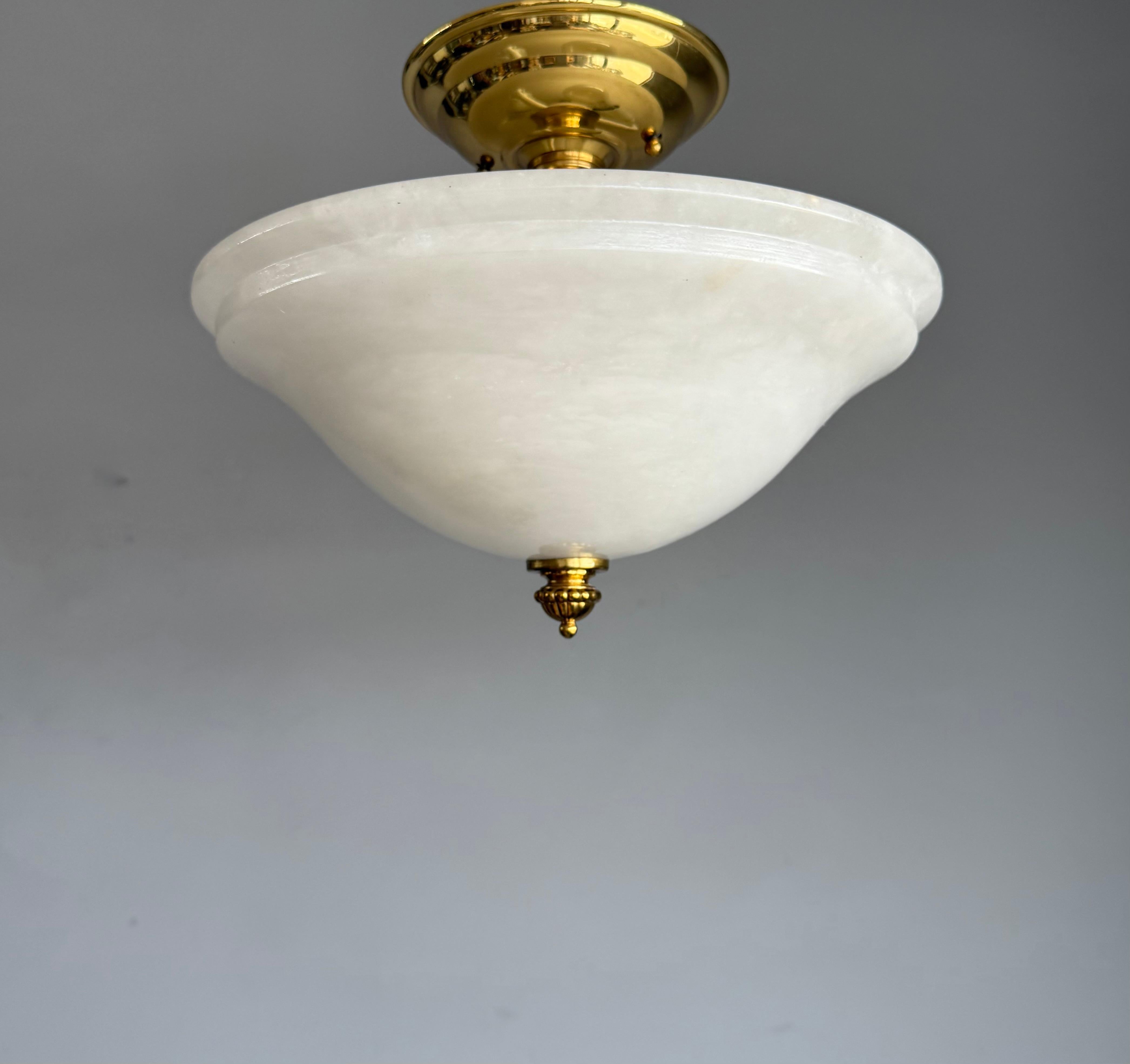 Beautiful mineral stone flush mount from the European late 20th Century.

This wonderfully stylish and small size light fixture comes with a stunning carved and superbly polished white alabaster shade. Especially with the light switched on, it