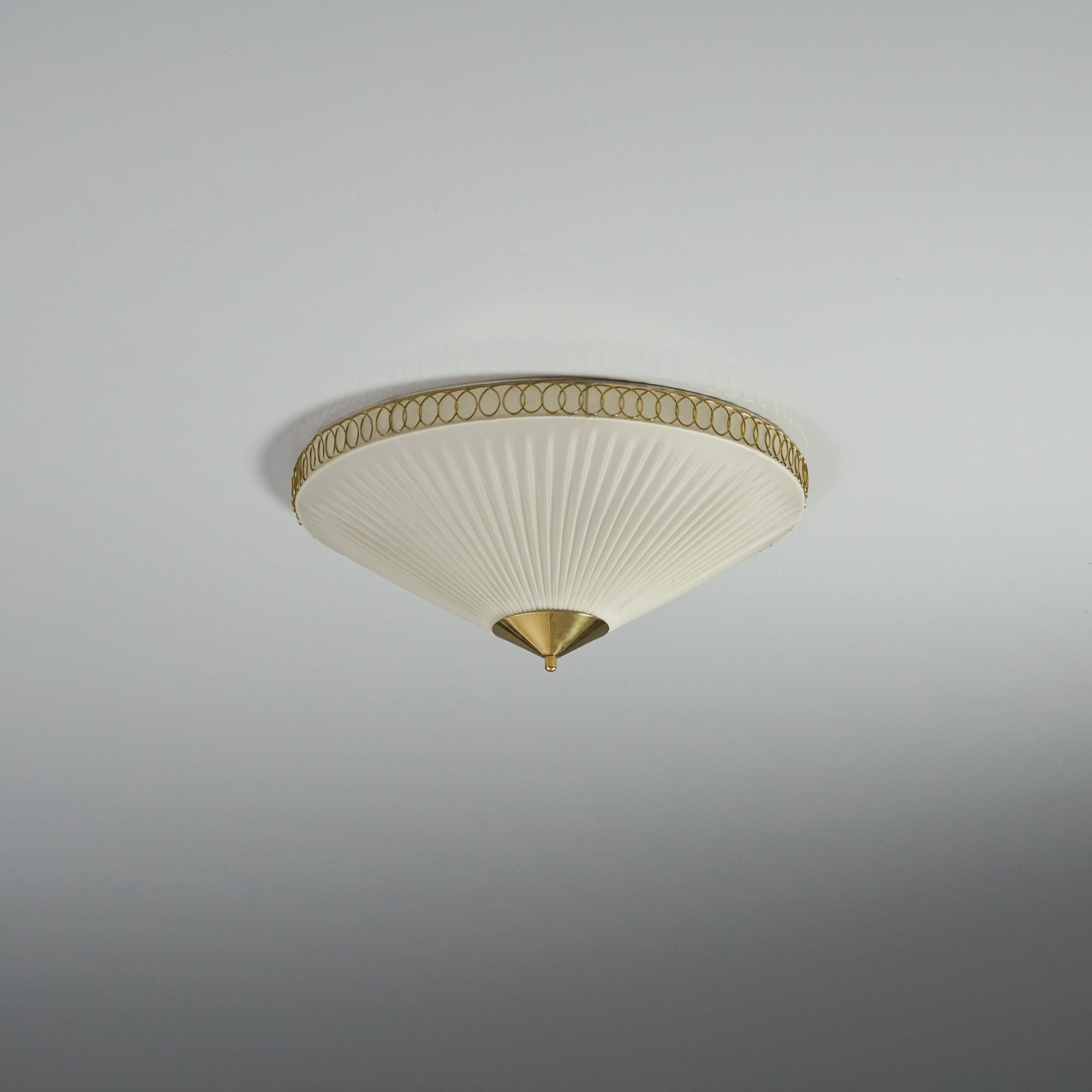 Flush mount, manufactured by Valinte Oy, 1960s. Plastic shade with brass details. Marked. Good vintage condition, patina consistent with age and use. 