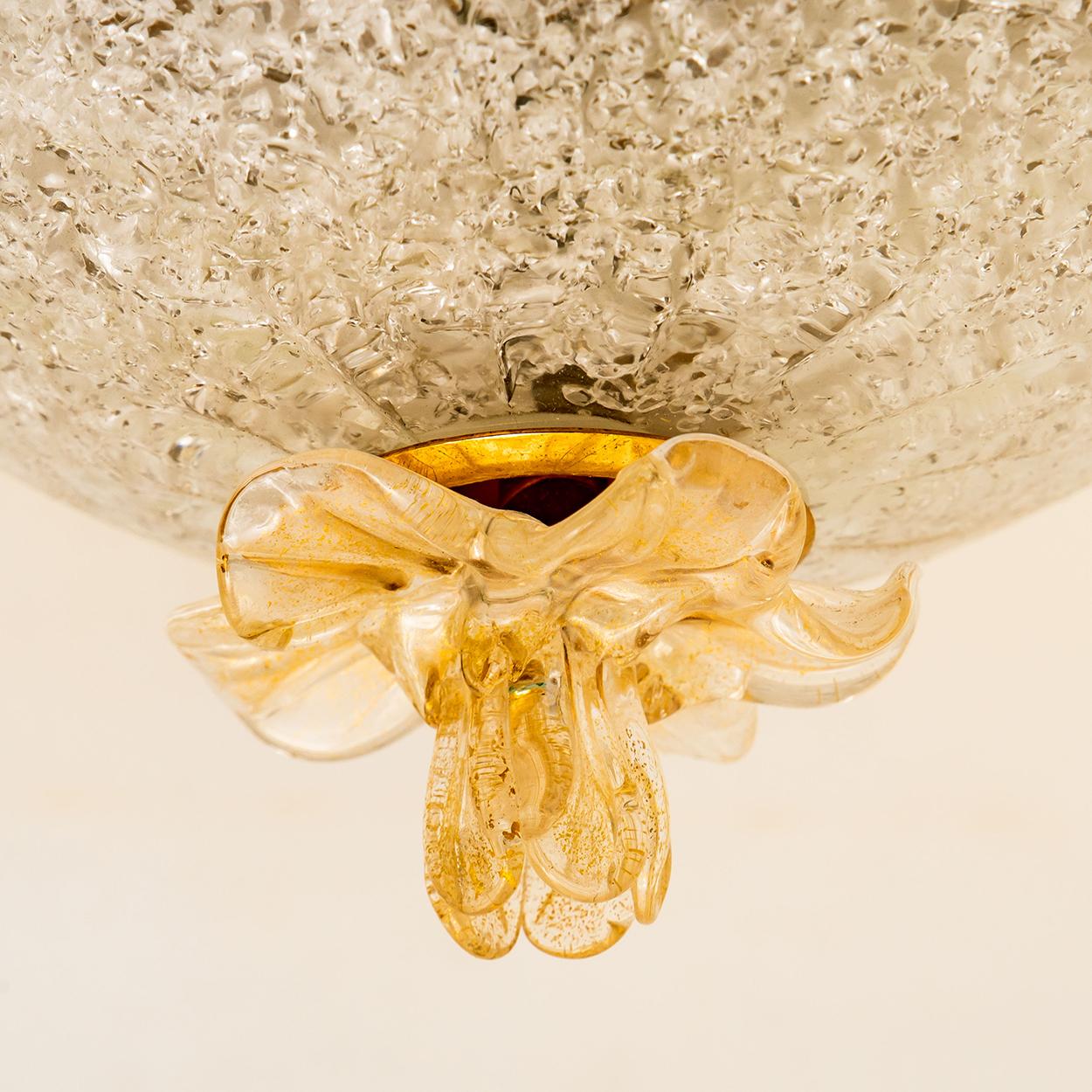 An elegant hand blown Murano glass flush mount by Barovier & Toso. Mounted on a brass frame. Many of tiny glass herds which are molded into the glass during its manufacture giving the piece a heavy ice appearance which refracts the light, filling a