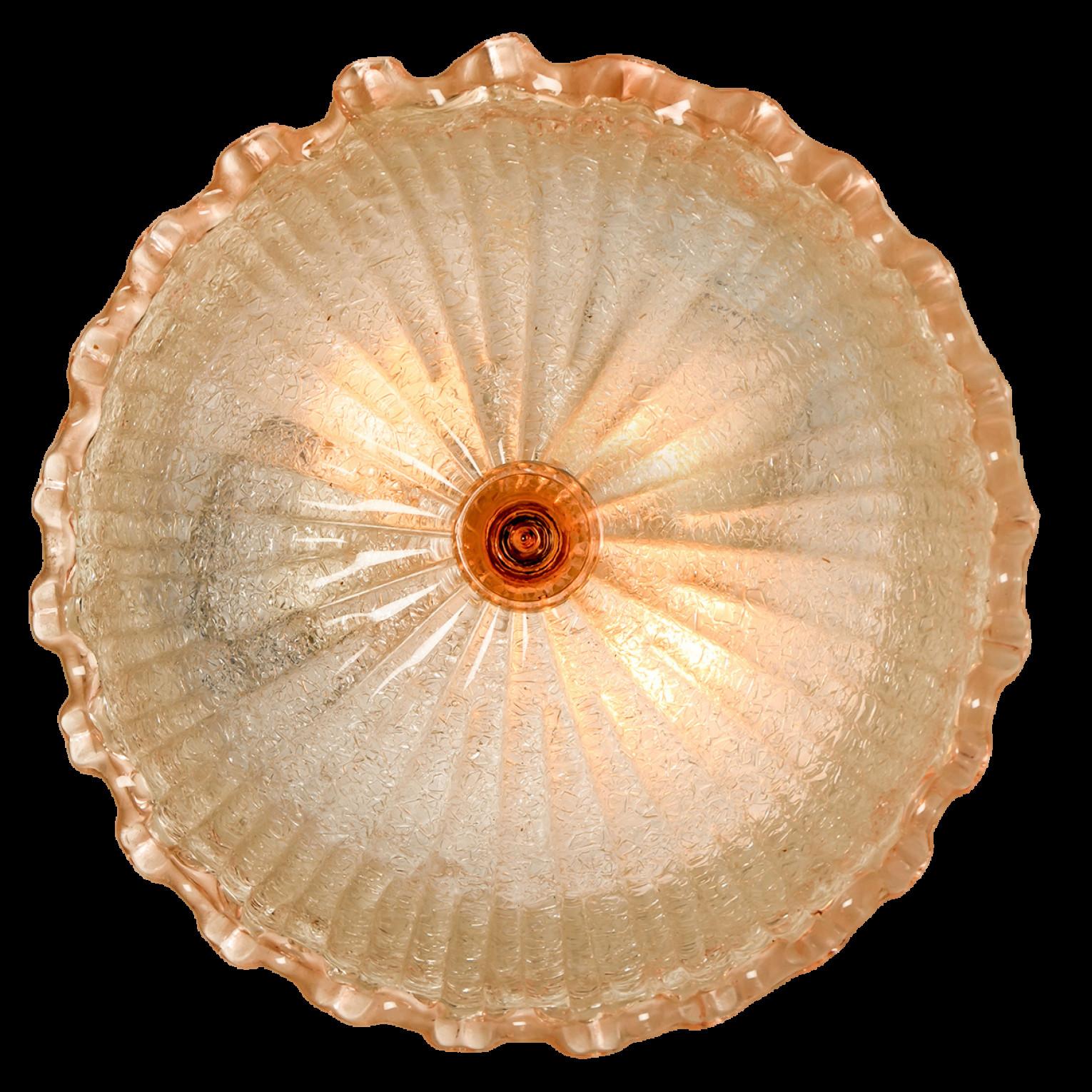 An elegant hand blown Murano glass flush mount in the style of Barovier & Toso. Mounted on a white frame. With light pink and clear colored glass. The textured glass refract light beautifully. The flush mount fills the room with a soft, warm and