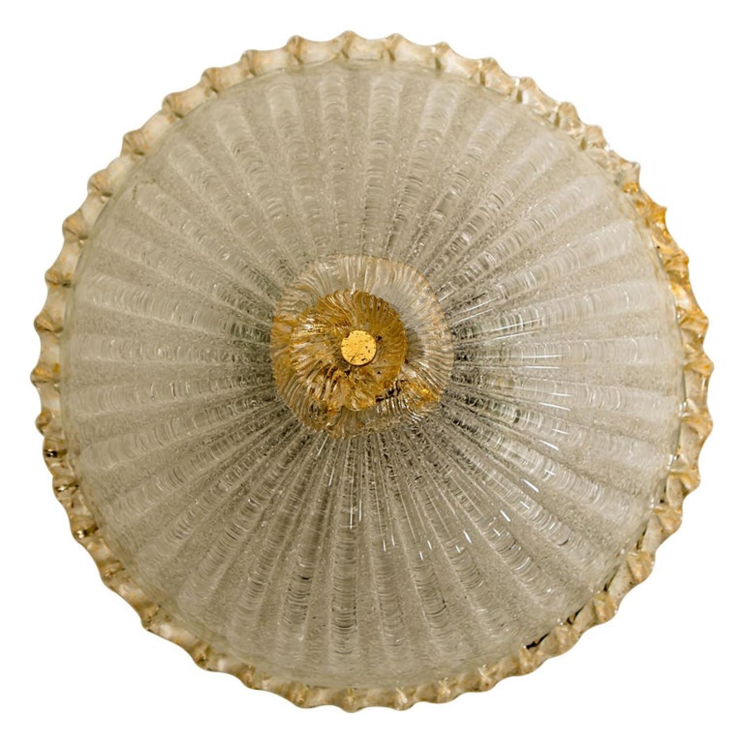 An elegant hand blown Murano glass flush mount in the style of Barovier & Toso. Mounted on a white frame. With light amber and clear colored glass. The textured glass refract light beautifully. The flush mount fills the room with a soft, warm and