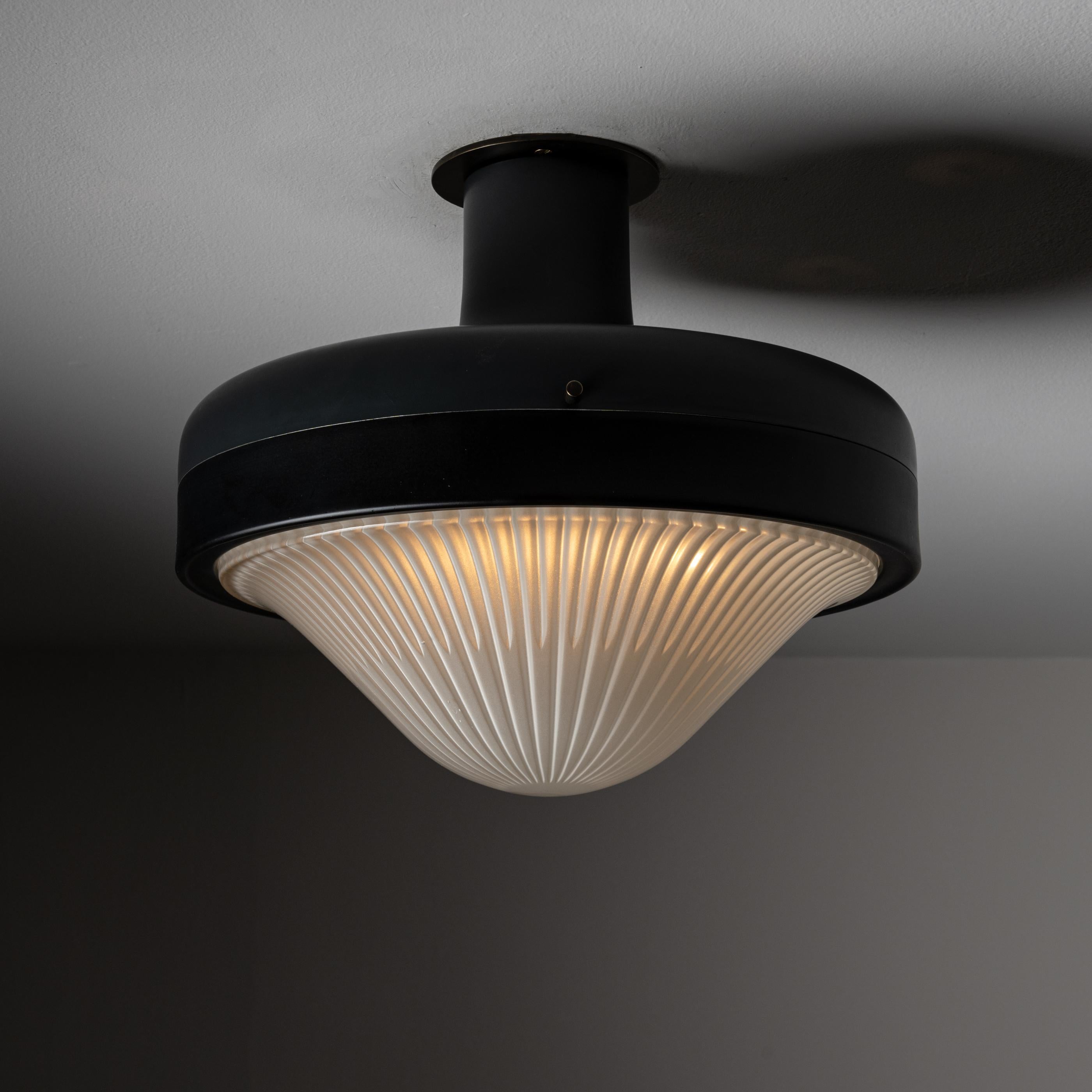 Flushmount by Greco. Circular matte finish ceiling fixture with beveled dew drop glass diffuser. Manufactured and designed in Italy circa 1950. We recommend using one E27 40W maximum bulb. Wired for US. Bulbs included as a one time courtesy.