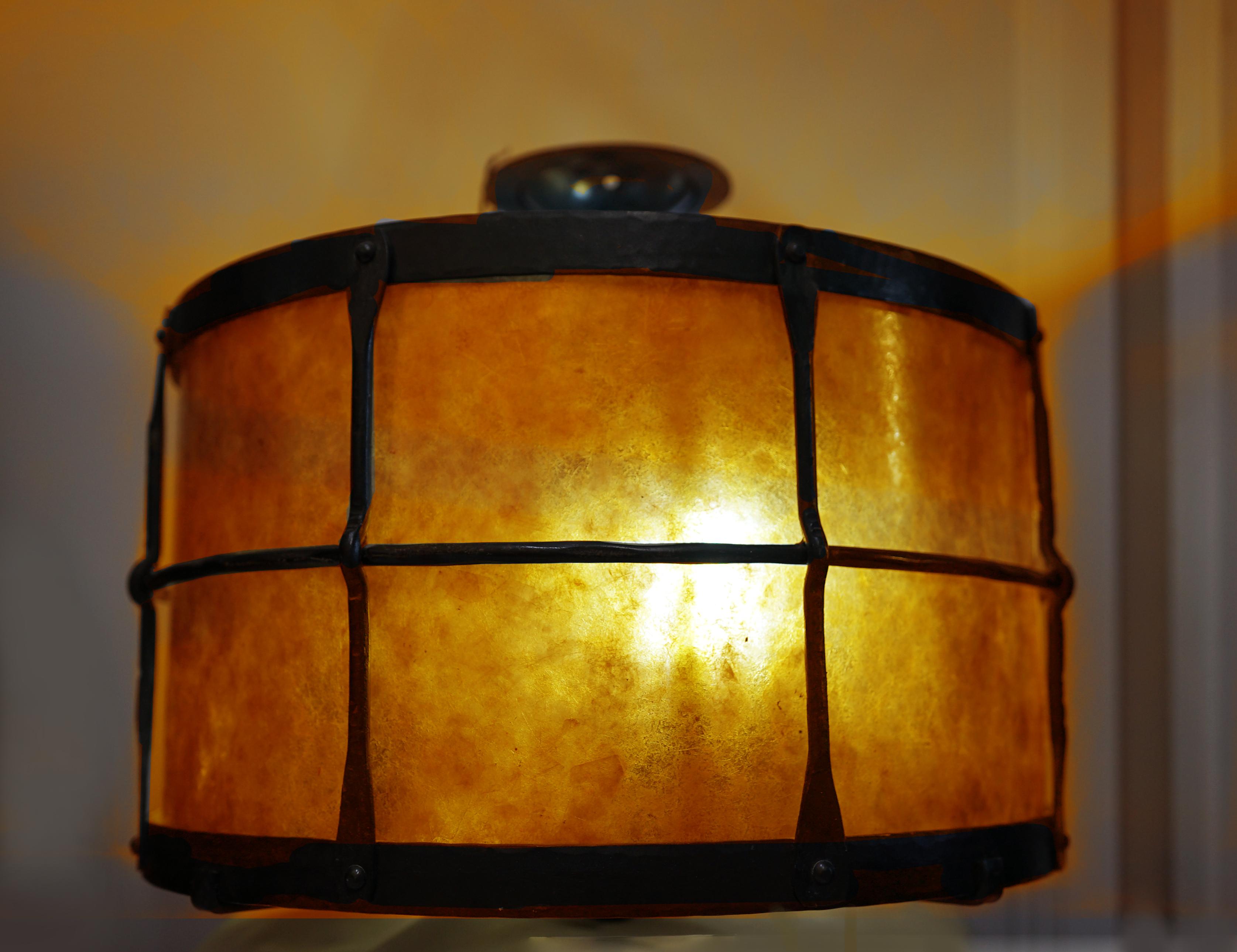 A combination of light and warmth combine to make this flushmount Mica shade drum fixture in wrought iron a great choice for a number of settings.  The feel is rustic and modern all at once. It is enhanced by the genuine Mica shade which creates a