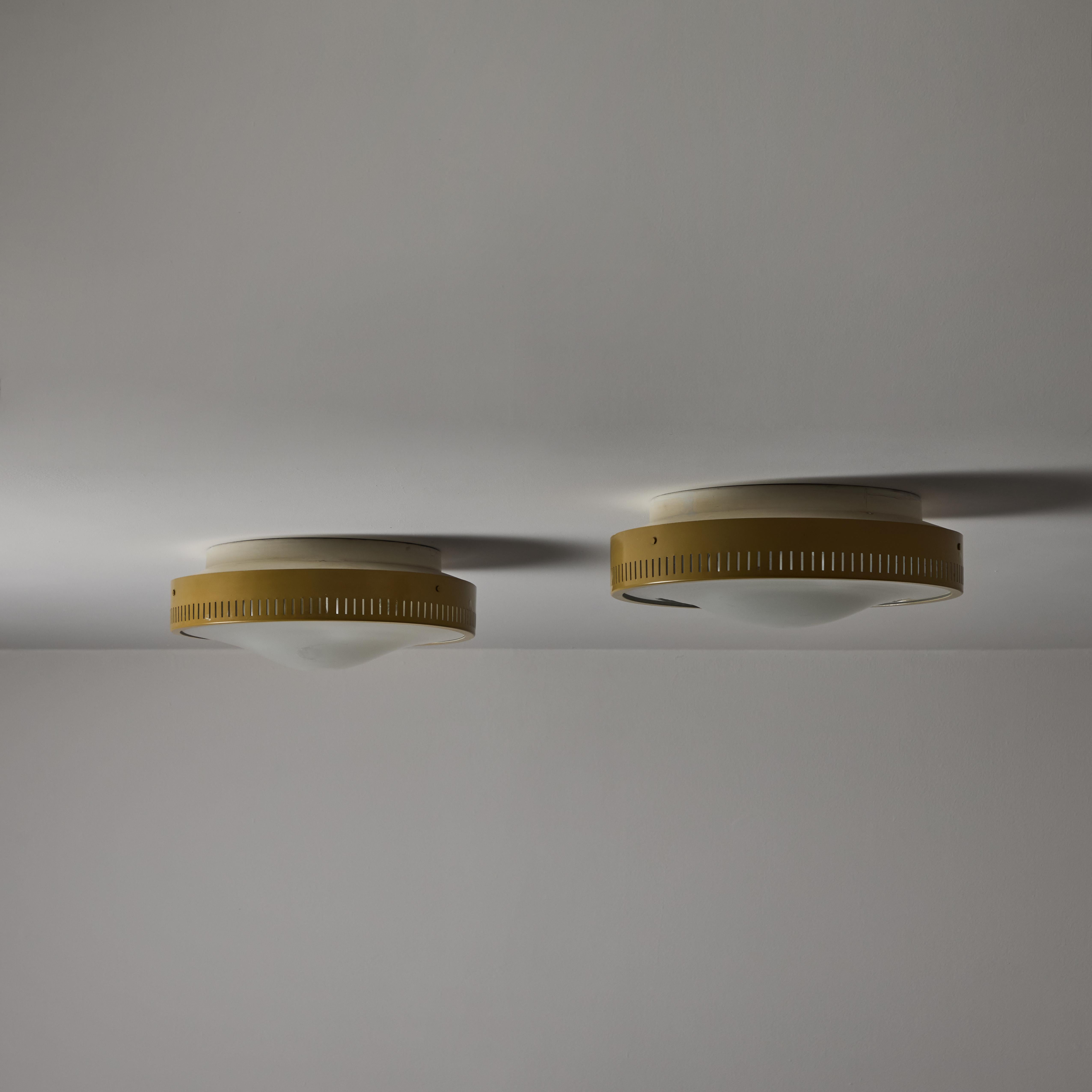 Flushmounts by Stilnovo. Designed and manufactured in Italy, circa the 1950s. Tan-colored outer housing rings meet with an etched glass diffuser. The outer housing is detailed with 360 degree slits which double as ventilation as well as a decorative
