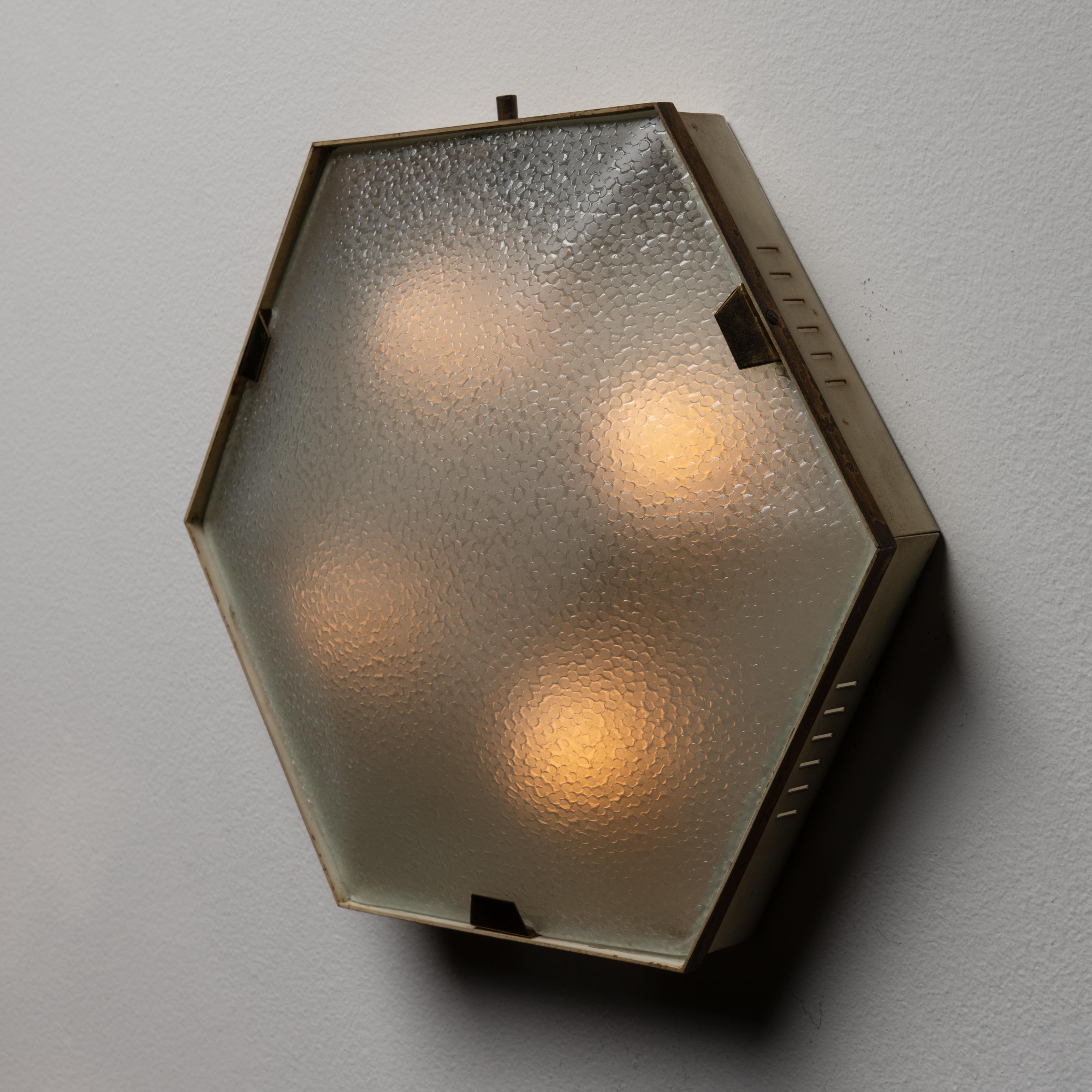 Flushmount by Stilnovo. Designed and manufactured in Italy, circa 1950. Stunning Stilnovo flush mounts, composed of minimal brass frames and shades made from textured glass. We recommend using 40w maximum E14 bulbs. Rewired for US standards. Bulbs