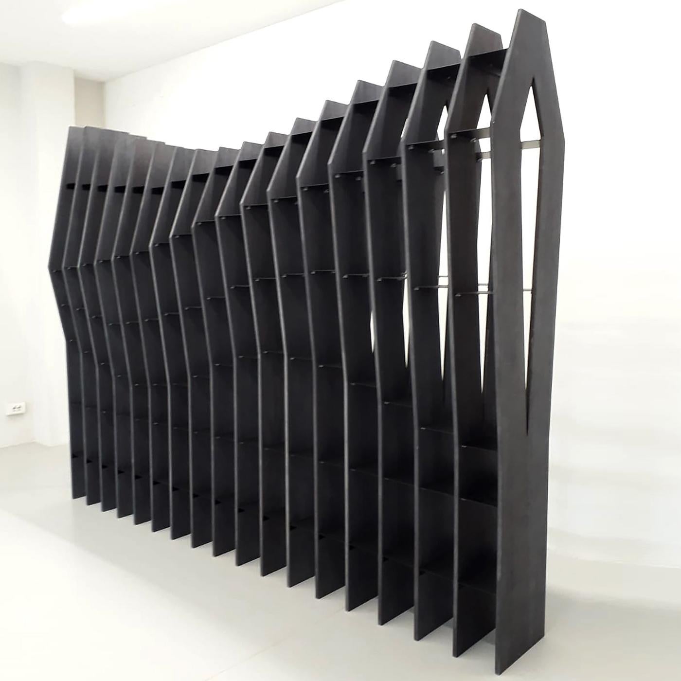 This stylish, unique bookcase can be used to divide open spaces in homes, bars, cafés, restaurants, offices and hotels. Featuring enameled iron shelves, the black finish of its Tanganyika walnut structure is made from powdered grape must and