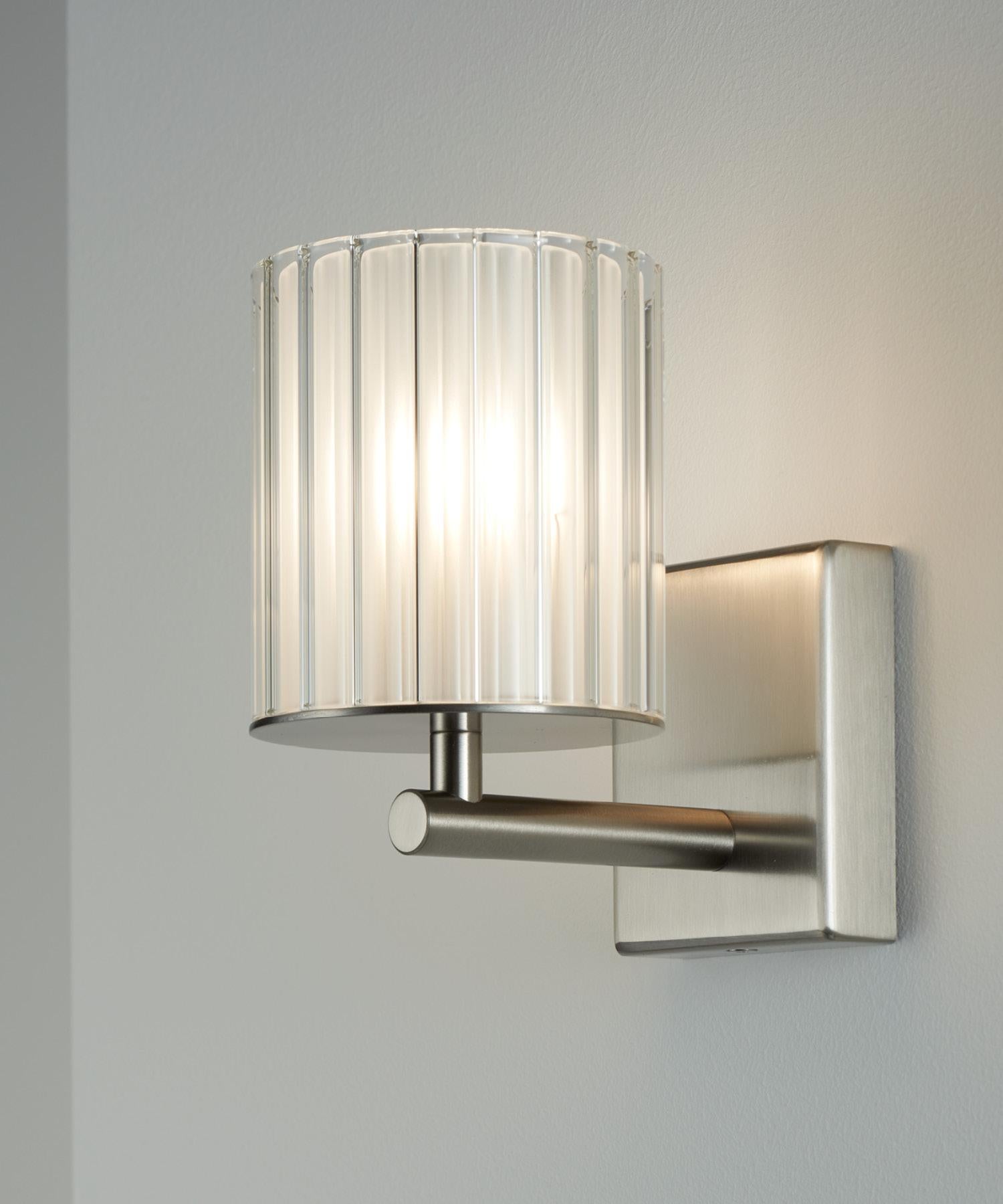 The flute wall light's frosted glass diffuser produces a soft, subtle glow that is ideal for a range of applications. It is the perfect accompaniment to the Flute Pendant or Chandelier, working brilliantly to build continuity throughout your