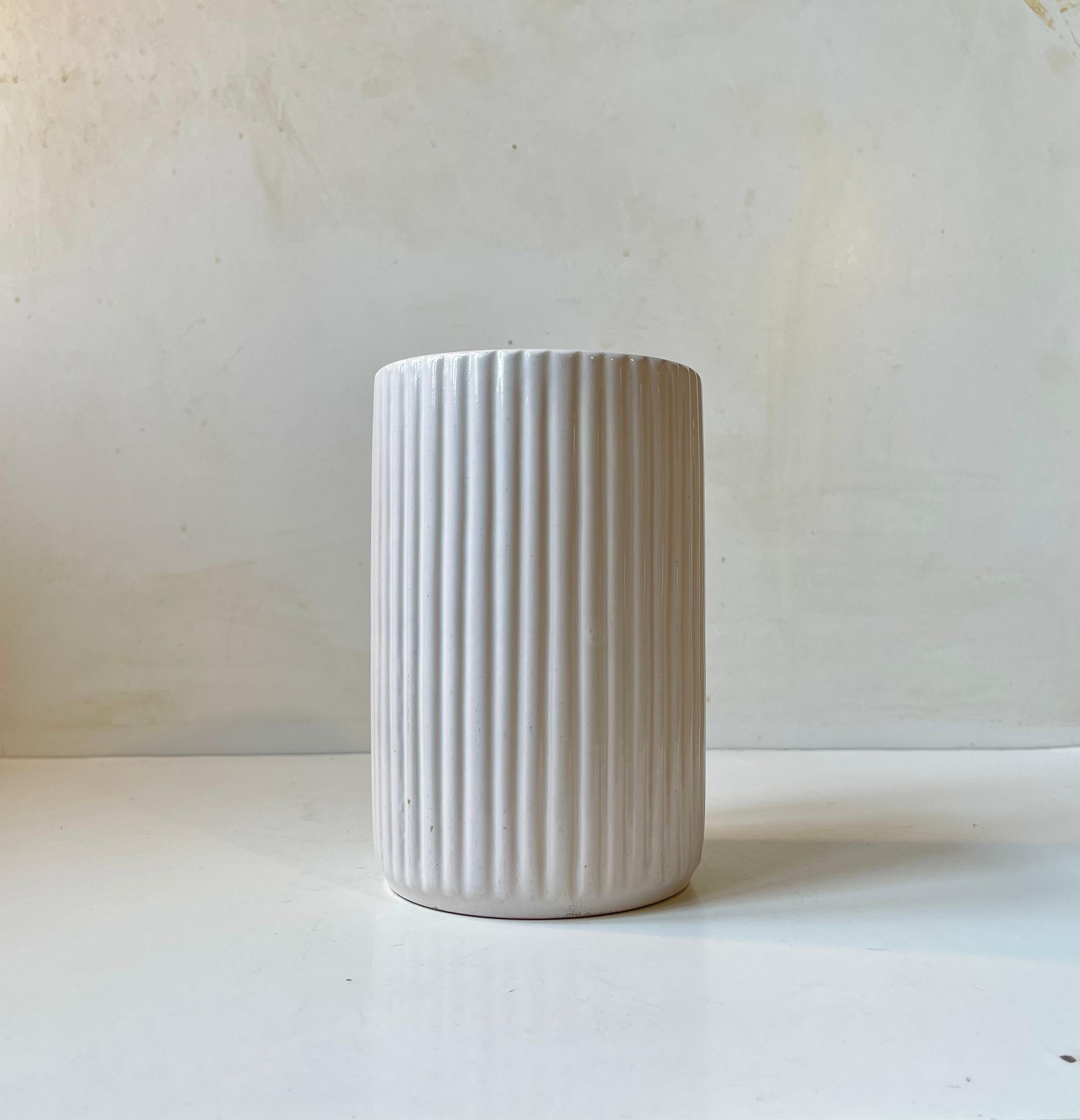 Large vase decorated with vertical ribbings and white glaze. Strict architectural derived Art Deco styling. Very similar to the iconic Lyngby Vases and Arne Bangs form-language. But this one was designed and manufactured by L. Hjorth on the Island