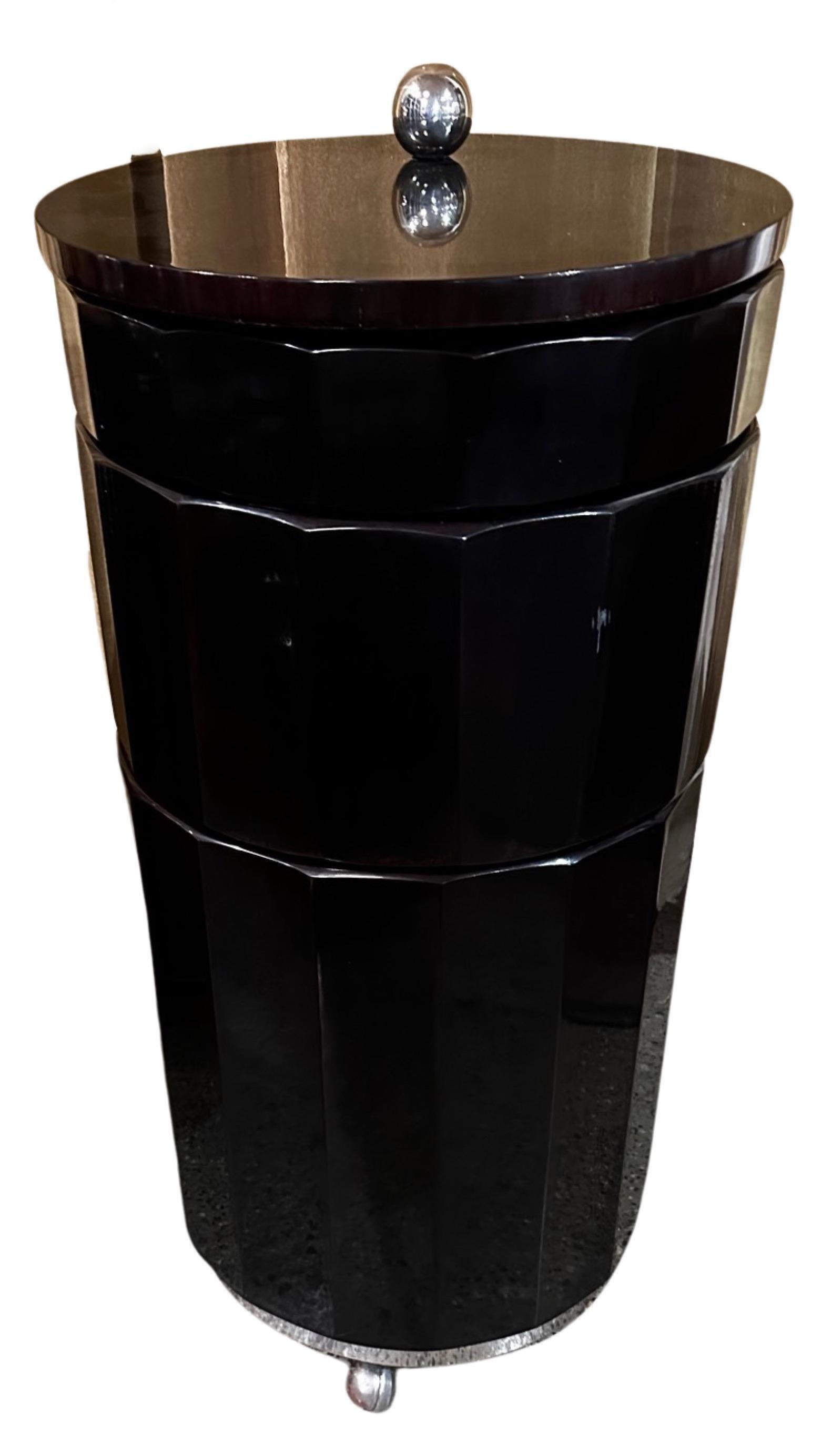 Art Deco Styled Bar Cart, like an elegant  ”Barrel of Fun” with a fluted ebonized exterior and red lacquer interior and all of it mounted on casters and “ready to roll”.  When closed, with its smartly black top it makes a slim side table, then the