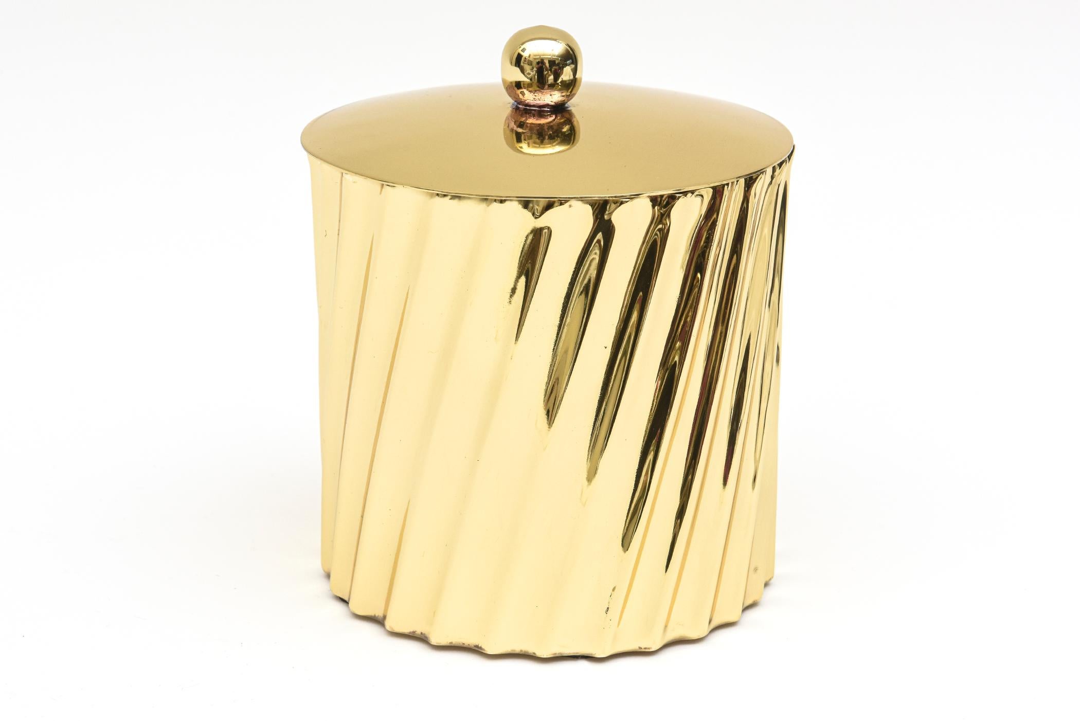 This fabulous vintage fluted and twisted brass Mid-Century Modern box has a lid with a ball on top. The box is from the 50s and has been professionally polished. it makes a great desk accessory for a woman or a man and is very chic. These kind of