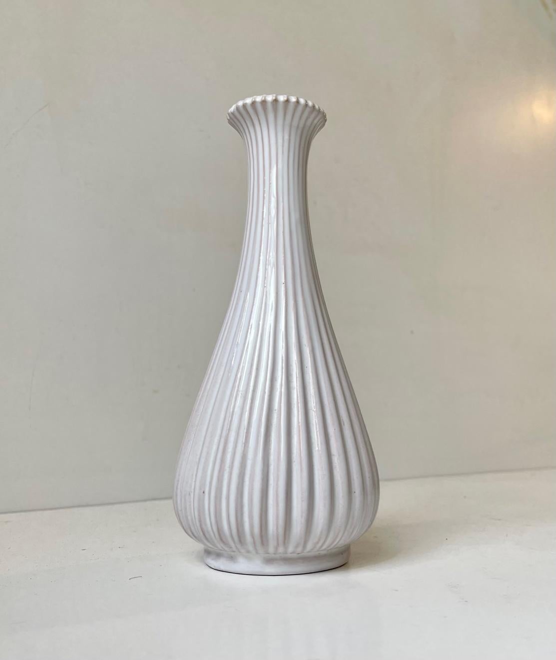 Art deco revival ceramic vase from the 1950s. Fluted fully glazed corpus in white glaze. Its designed by Eslau in Denmark and manufactured at their own Studio during the 1950s or 60s. This style has clear reference points to Arne Bang in particular.