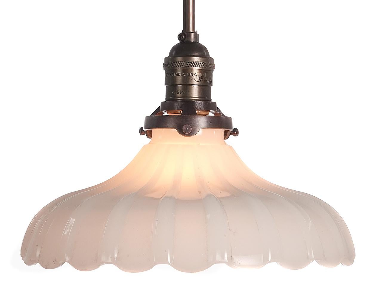 Softly curved bell shaped pendants are a classic. They feel at home with any style decor. This example is an extra heavy thick-thin pattern in cast clam broth glass with a scalloped edge. The lamps are priced per so you can buy just one or the