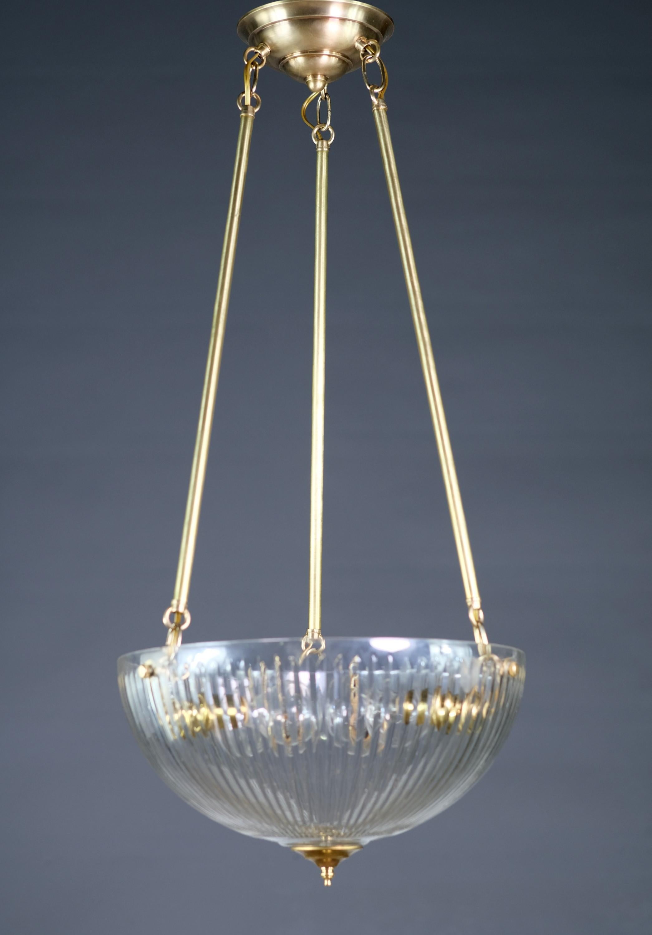 Brushed brass pendant light. Features a clear ribbed glass dish shade. Cleaned and rewired. Small quantity available at time of posting. Priced each. Please inquire. Please note, this item is located in our Scranton, PA location.