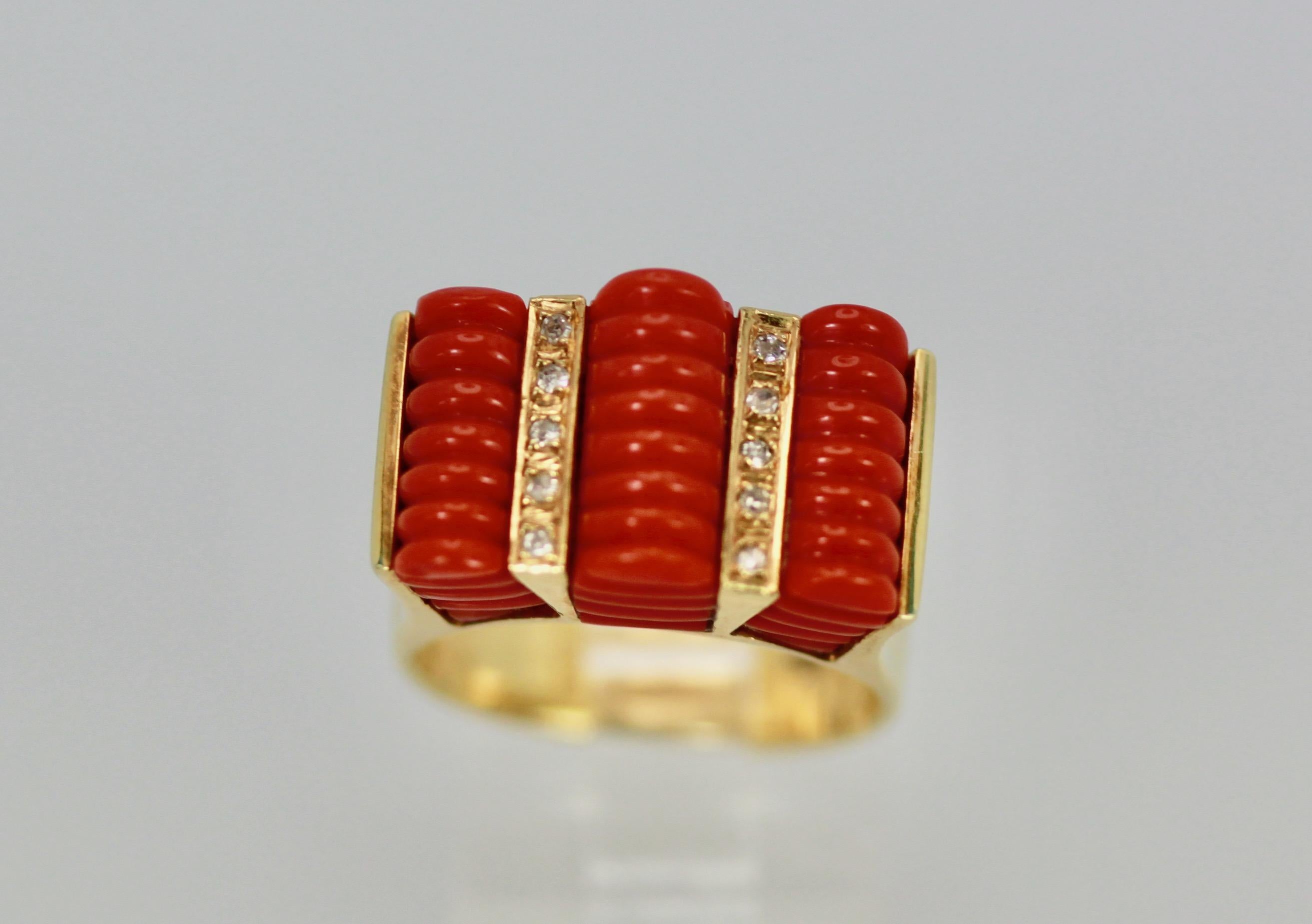 This fluted Coral ring is in near perfect condition.  The Coral is true mediterranean Coral as the color suggests.  There are two lines of Diamonds between the 3 sections of Coral.  Weight is 12.6 grams ring size 5 3/4 to 6.  This measures 18.75mm