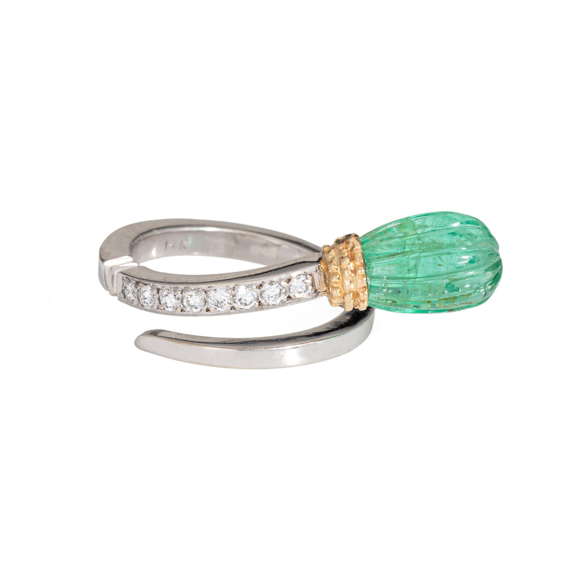 Stylish contemporary fluted emerald & diamond ring crafted in 14 karat white gold. 

Fluted emerald measures 10mm x 7.5mm. Diamonds total an estimated 0.08 carats (estimated at H-I color and Si1-I1 clarity). Note: internal fissures to the emerald.  