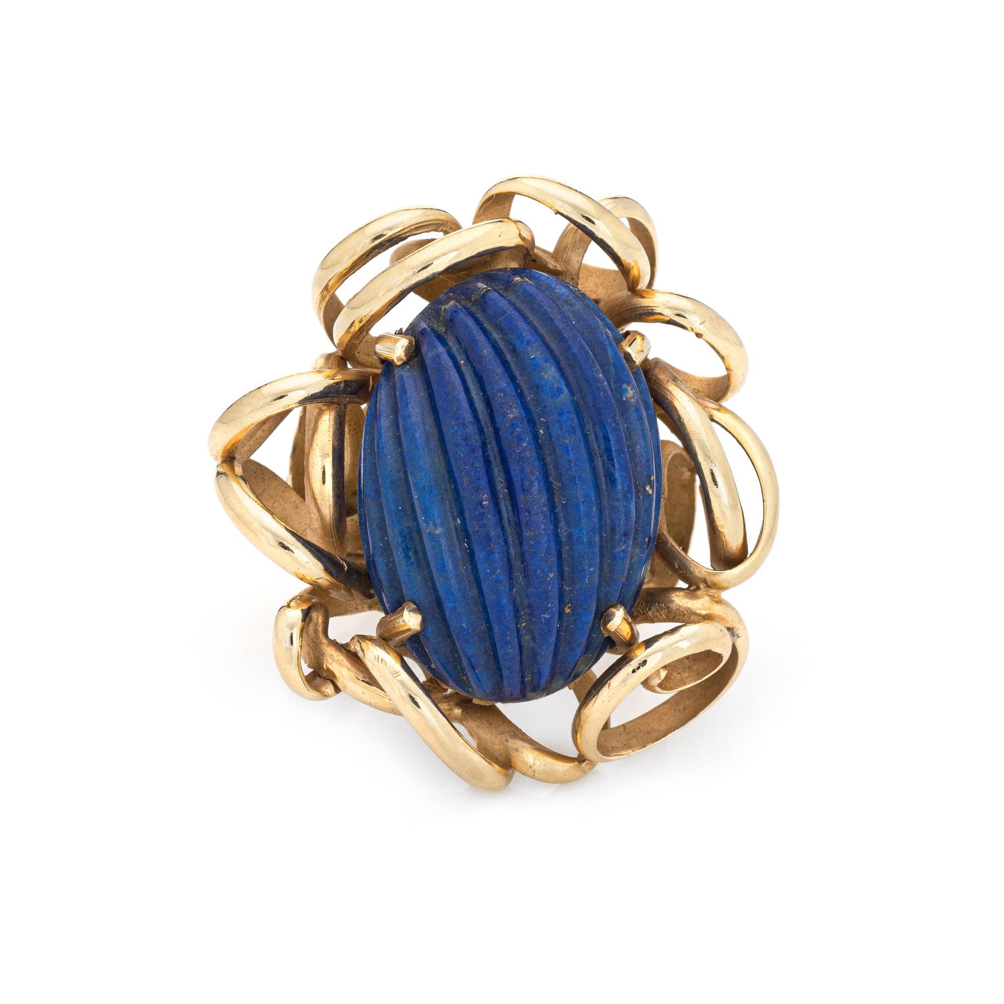 Stylish fluted lapis lazuli vintage cocktail ring (circa 1960s) crafted in 14 karat yellow gold. 

Fluted lapis measures 22mm x 16mm. The lapis is in excellent condition and free of cracks or chips. 

The fluted lapis is set into an elaborate mount