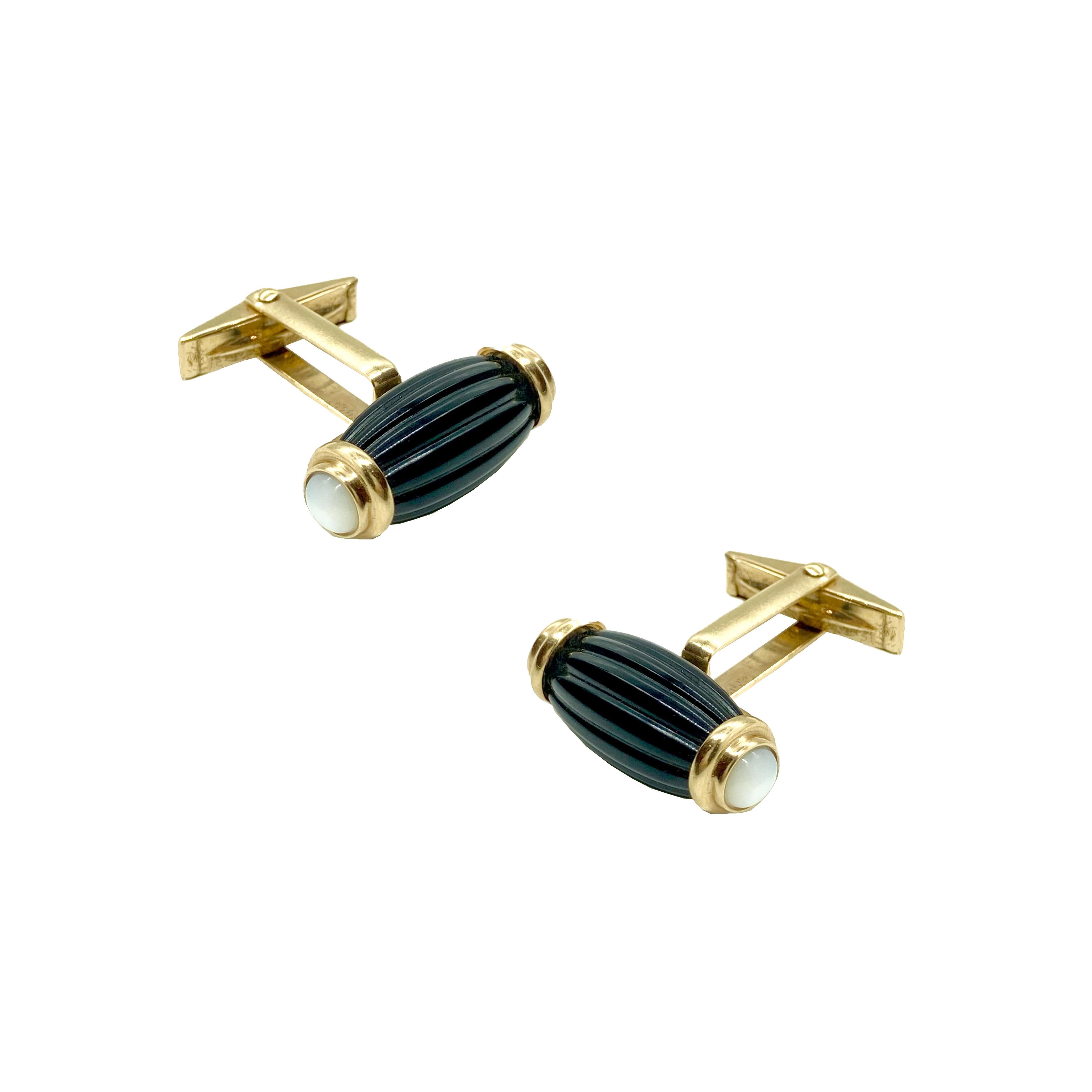 Chic gold cufflinks featuring a fluted onyx and mother of pearl design. Circa 1950.