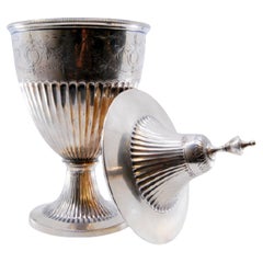 Fluted silver candy box in low relief with engravings and placed on a round base