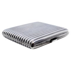 Fluted silver case with gold interior, ribbons and hinged lid