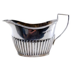 Fluted silver gravy boat with beaded handle Fluted silver gravy boat with beaded handle