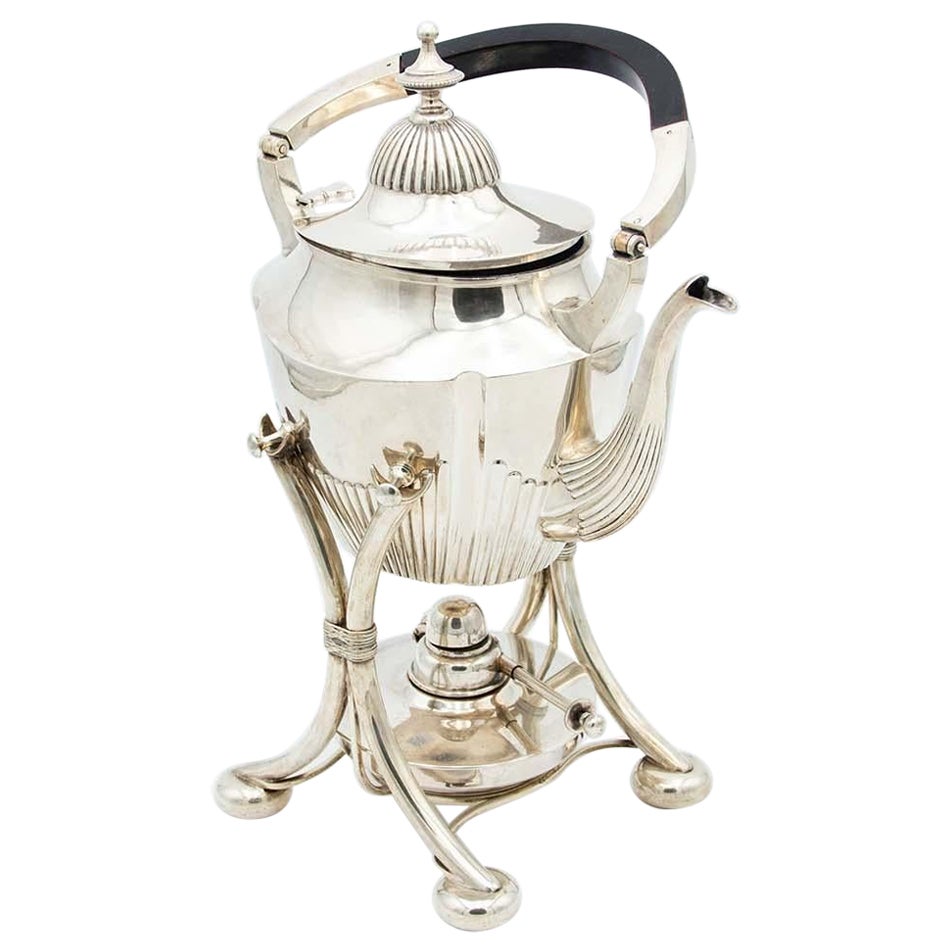 Fluted silver kettle on trivet with lamp, four raised feet and wood-inset handle