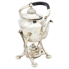 Fluted silver kettle on trivet with lamp, four raised feet and wood-inset handle
