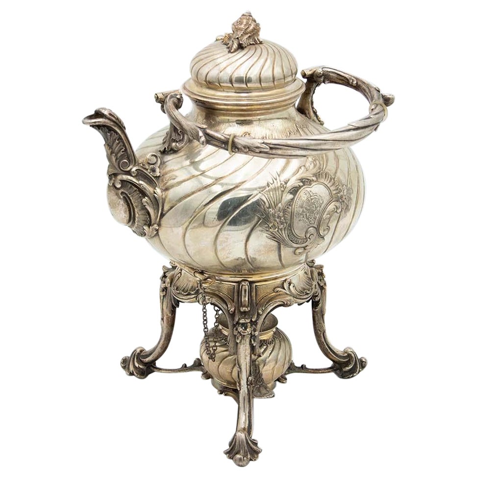 Fluted silver kettle on trivet with lamp, four raised feet and wood-inset handle