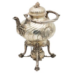 Fluted silver kettle on trivet with lamp, four raised feet and wood-inset handle