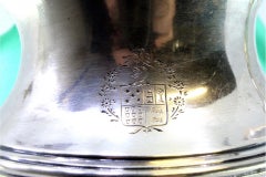 Fluted silver milk jug with coat of arms, knobbed lid, and trim